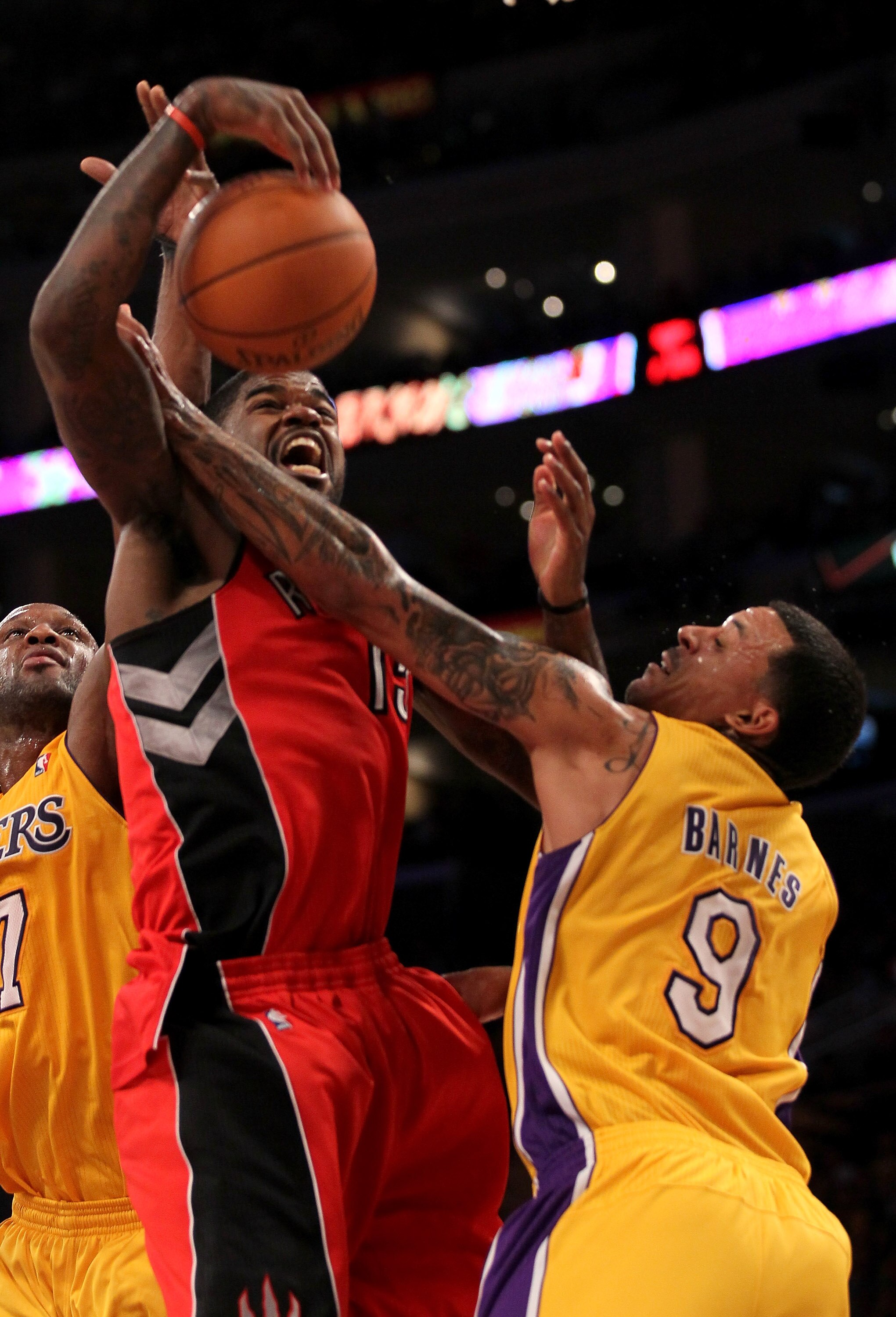 LOS ANGELES, CA - NOVEMBER 05:  Amir Johnson #15 of  the Toronto Raptors battles for the ball with Matt Barnes #9 of the Los Angeles Lakers at Staples Center on November 5, 2010 in Los Angeles, California.  The Lakers won 108-102.   NOTE TO USER: User exp