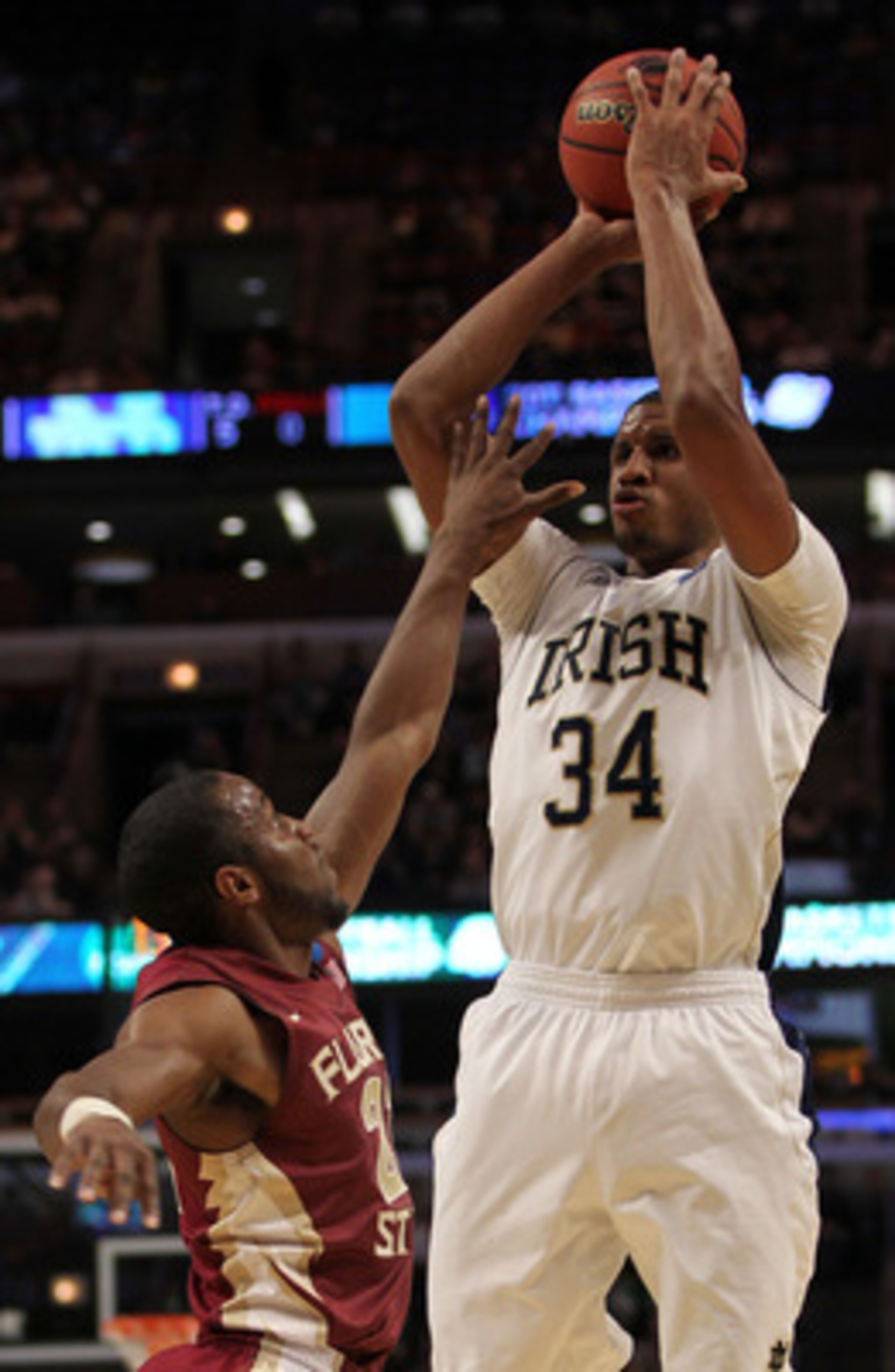 CHICAGO, IL - MARCH 20:  Carleton Scott #34 of the Notre Dame Fighting Irish shoots against Michael Snaer #21 of the Florida State Seminoles in the first half during the third round of the 2011 NCAA men's basketball tournament at the United Center on Marc