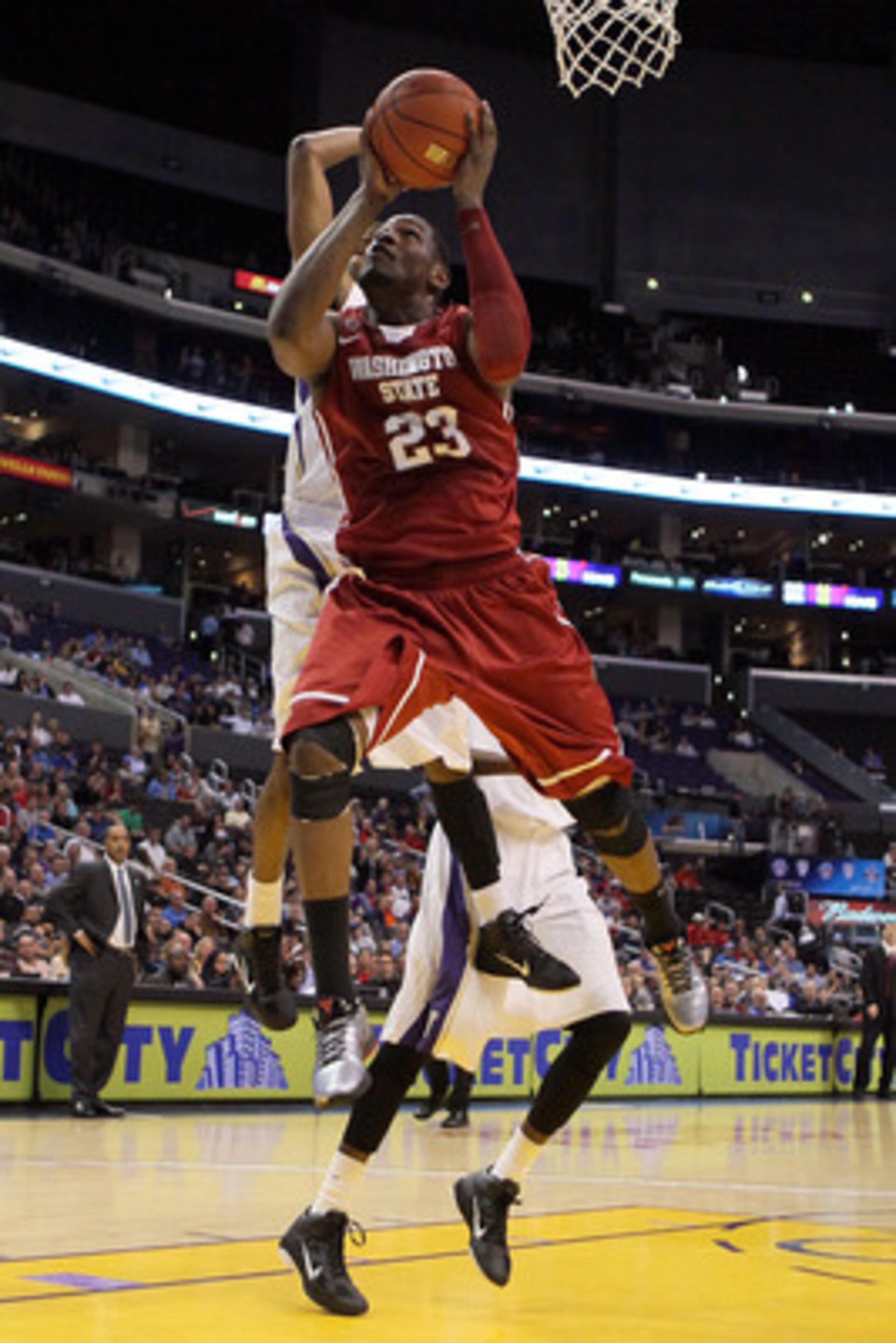 LOS ANGELES, CA - MARCH 10:  DeAngelo Casto #23 of the Washington State Cougars goes up for a shot in the lane against the Washington Huskies in the quarterfinals of the 2011 Pacific Life Pac-10 Men's Basketball Tournament at Staples Center on March 10, 2