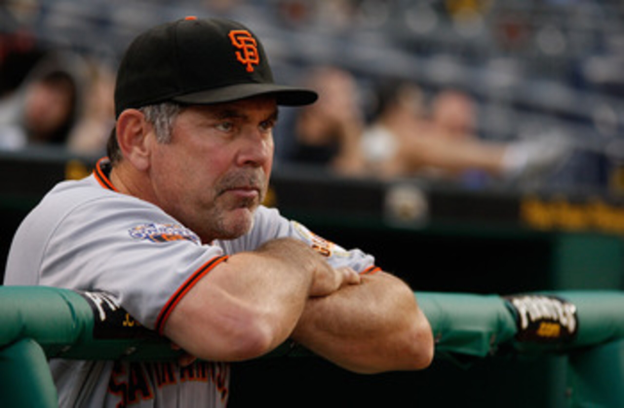PITTSBURGH - APRIL 26:  Manager Bruce Bochy #15 of the San Francisco Giants watches the grounds crew prepare the field during a rain delay before the game against the Pittsburgh Pirates on April 26, 2011 at PNC Park in Pittsburgh, Pennsylvania.  (Photo by