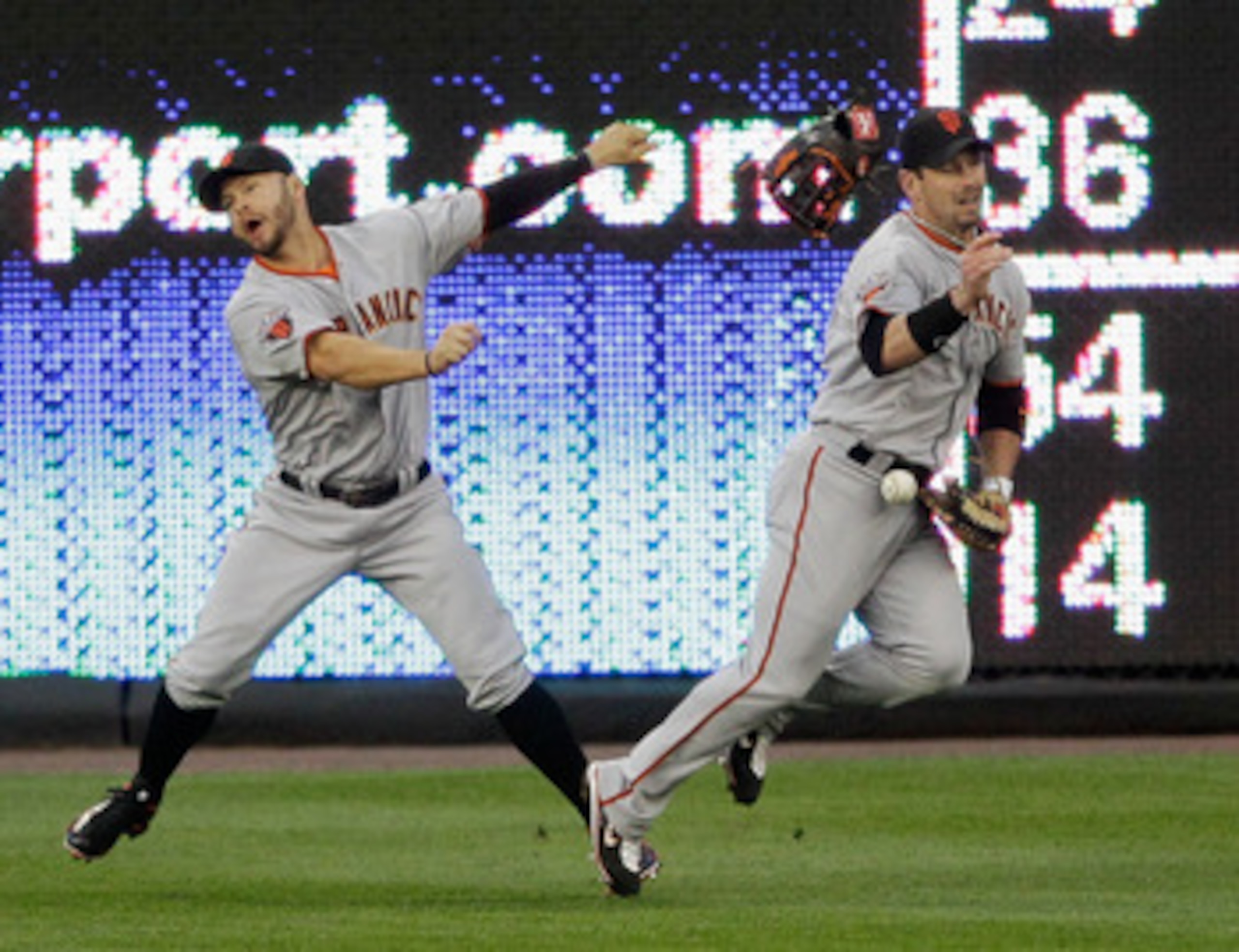 WASHINGTON, DC - APRIL 29: Center fielder Aaron Rowand #33 (R) of the San Francisco Giants drops a ball hit Wilson Ramos #3 of the Washington Nationals (not pictured) after colliding with teammate Cody Ross #13 (R) during the second inning at Nationals Pa