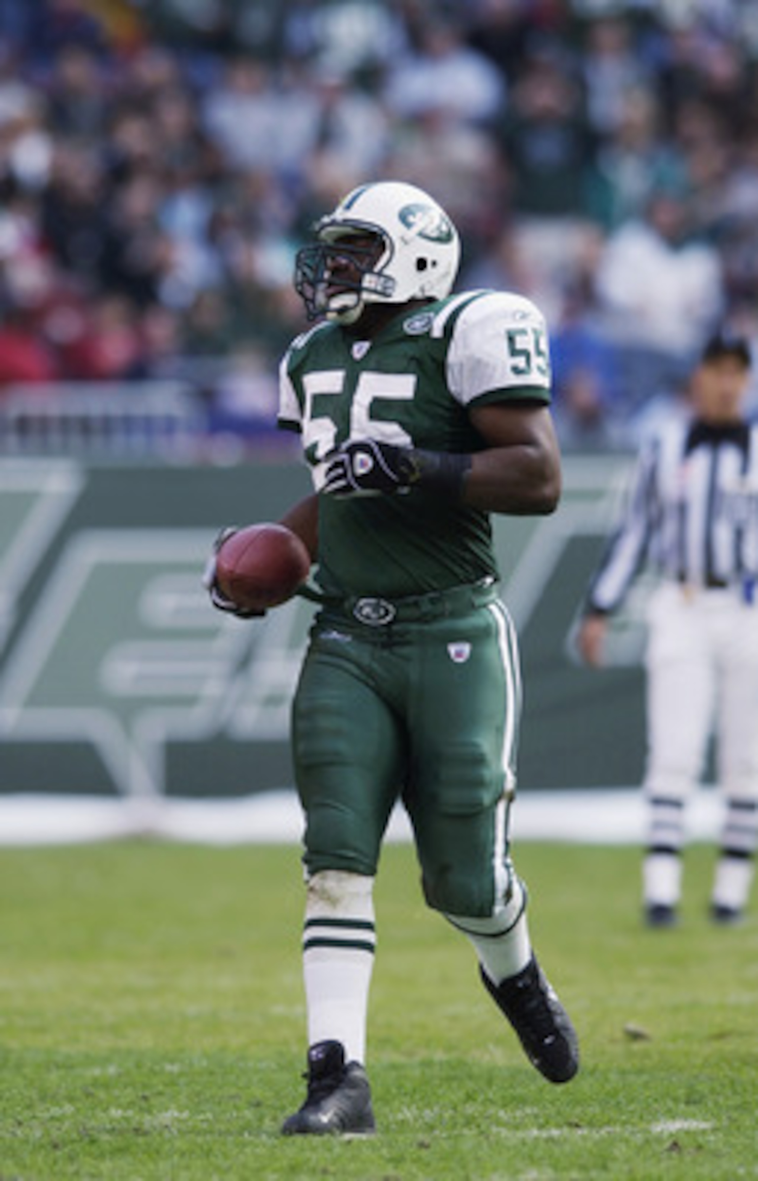 EAST RUTHERFORD, NJ - OCTOBER 27:  Middle Linebacker Marvin Jones #55 of the New York Jets runs with the ball during the NFL game against the Cleveland Browns at Giant Stadium on October 27, 2002 in East Rutherford, New Jersey. The Browns defeated the Jet