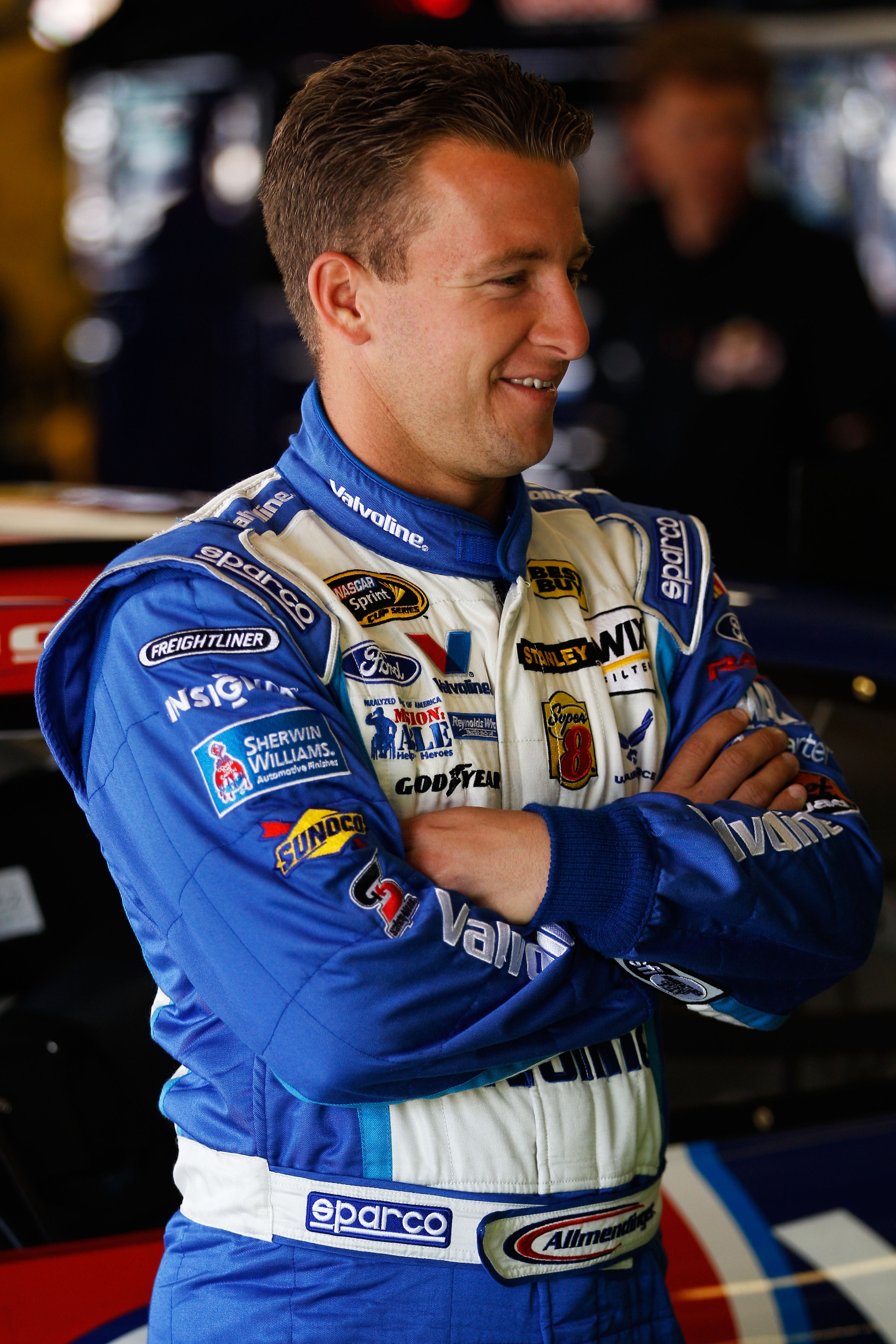 FORT WORTH, TX - APRIL 08:  A.J. Allmendinger, driver of the #43 Valvoline Ford, stands in the garage area during practice for the NASCAR Sprint Cup Series Samsung Mobile 500 at Texas Motor Speedway on April 8, 2011 in Fort Worth, Texas.  (Photo by Chris