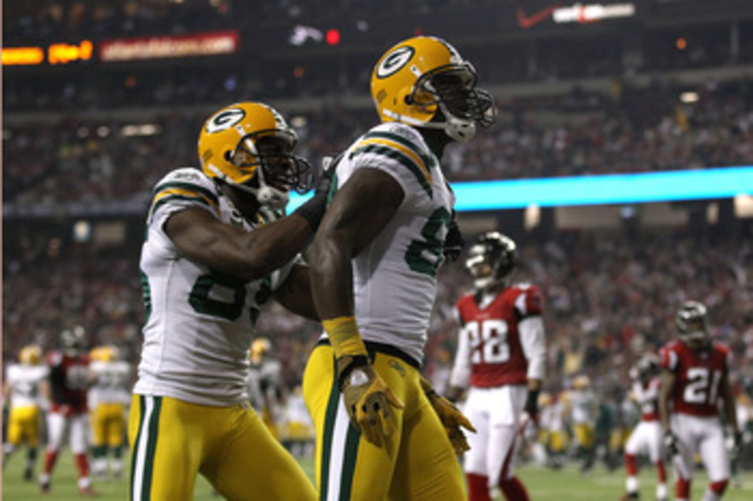 ATLANTA, GA - JANUARY 15:  James Jones #89 (R) and Greg Jennings #85 of the Green Bay Packers celebrate after Jones scored a 20-yard touchdown in the second quarter against the Atlanta Falcons during their 2011 NFC divisional playoff game at Georgia Dome 