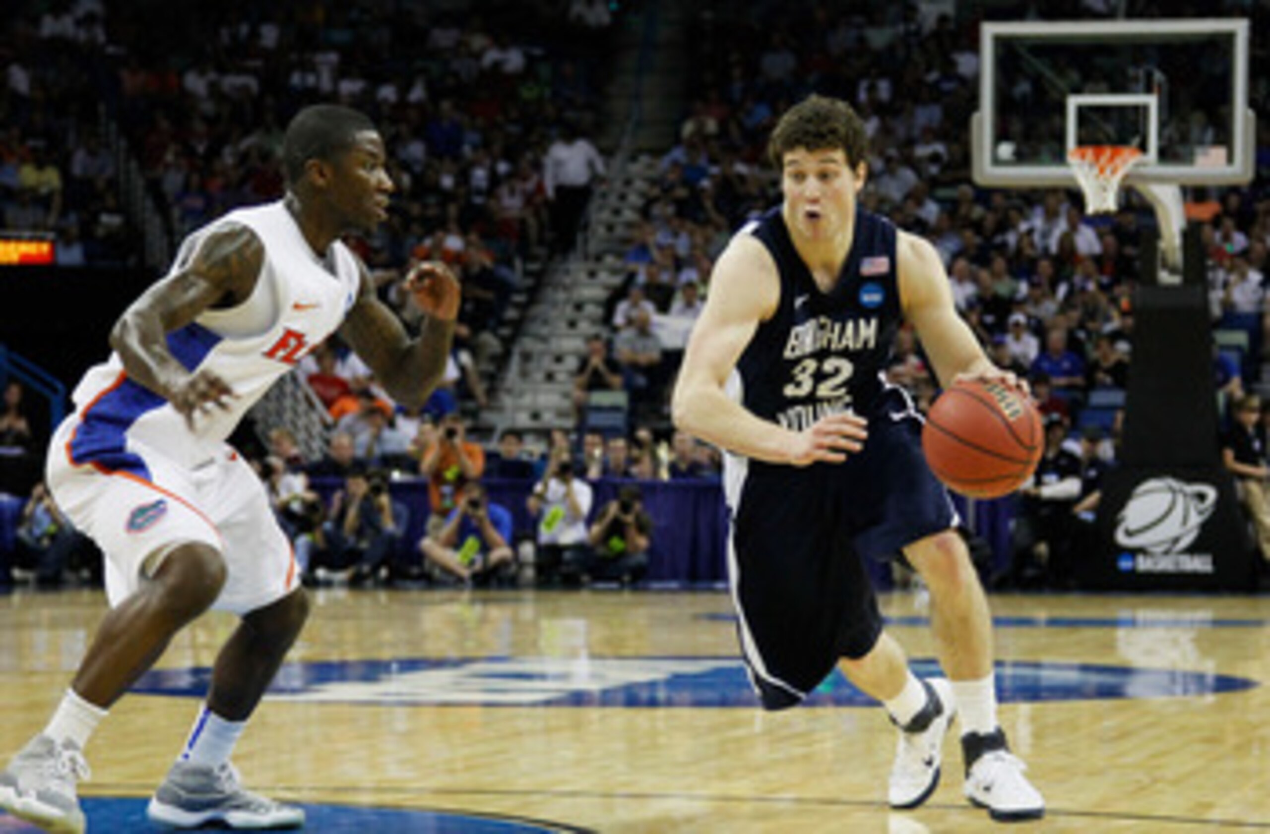 NEW ORLEANS, LA - MARCH 24:  Jimmer Fredette #32 of the Brigham Young Cougars drives past Kenny Boynton #1 of the Florida Gators during the Southeast regional of the 2011 NCAA men's basketball tournament at New Orleans Arena on March 24, 2011 in New Orlea