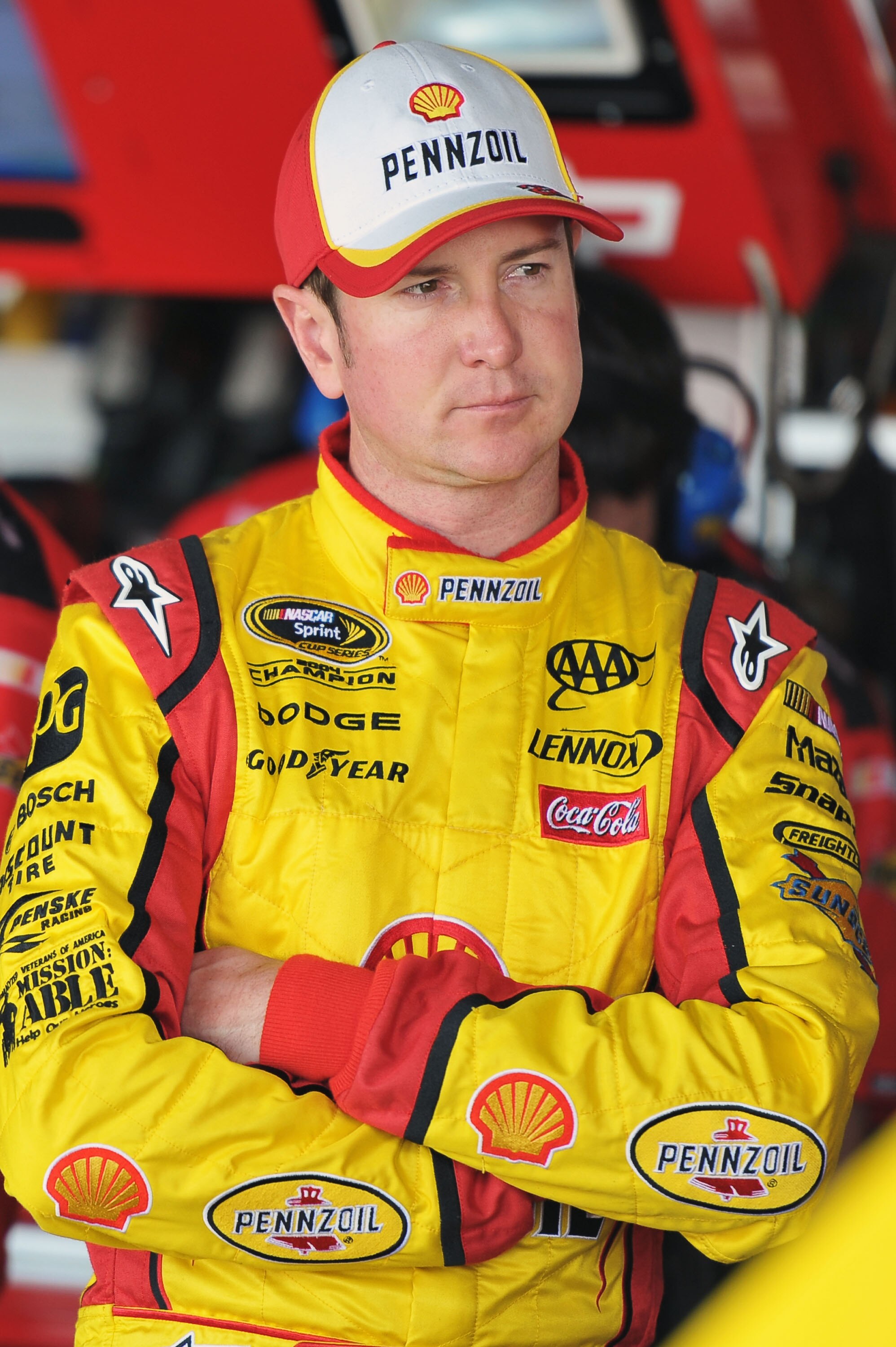 RICHMOND, VA - APRIL 29:  Kurt Busch, driver of the #22 Shell/Pennzoil Dodge, stands in the garage area during practice for the NASCAR Sprint Cup Series Crown Royal Presents The Matthew & Daniel Hansen 400 at Richmond International Raceway on April 29, 20
