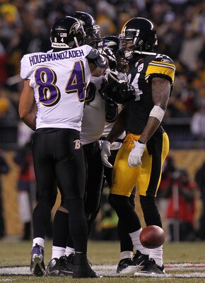 PITTSBURGH, PA - JANUARY 15:  Wide receiver T.J. Houshmandzadeh #84 of the Baltimore Ravens and cornerback Ike Taylor #24 of the Pittsburgh Steelers are separated after Houshmandzadeh was head butted by Taylor in the first quarter of the AFC Divisional Pl
