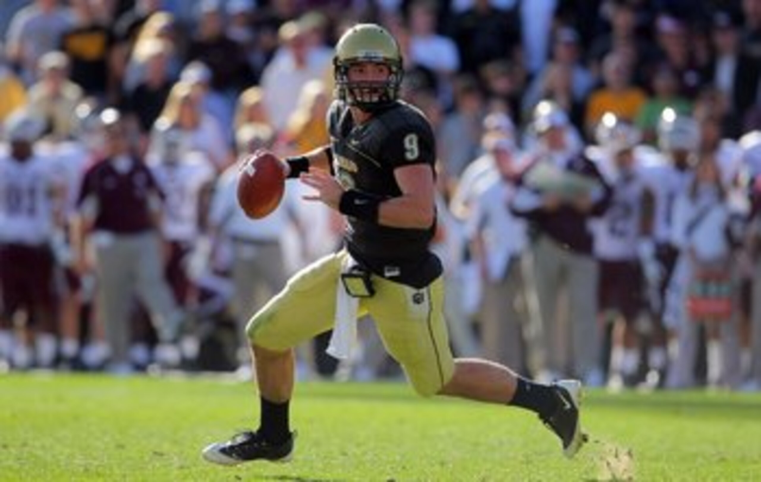 BOULDER, CO - NOVEMBER 07:  Quarterback Tyler Hansen #9 of the Colorado Buffaloes rolls out to deliver a pass against the Texas A&M Aggies during NCAA college football action at Folsom Field on November 7, 2009 in Boulder, Colorado. Colorado defeated Texa