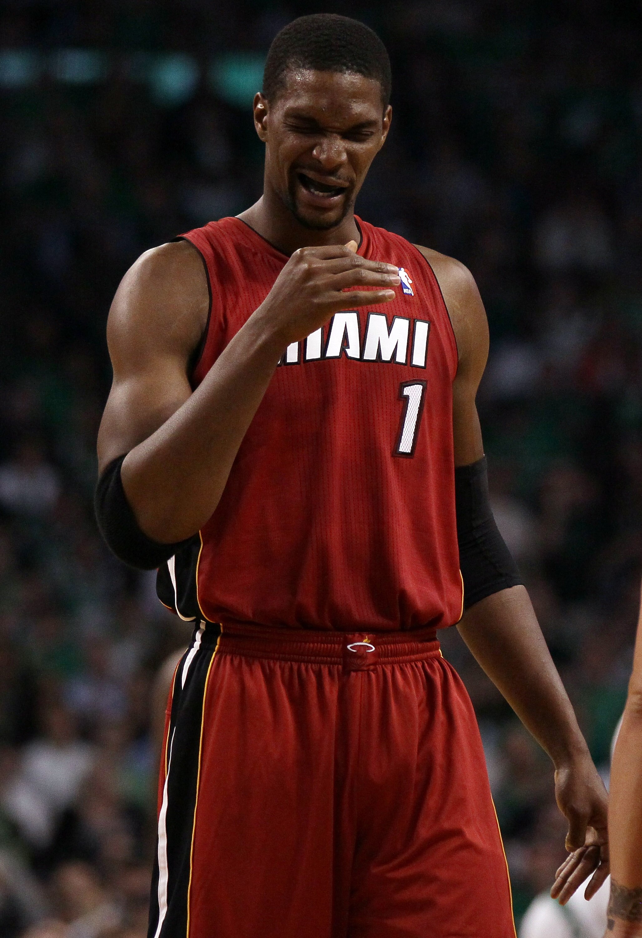BOSTON, MA - MAY 07:  Chris Bosh #1 of the Miami Heat winces after a play in the first quarter against the Boston Celtics in Game Three of the Eastern Conference Semifinals in the 2011 NBA Playoffs on May 7, 2011 at the TD Garden in Boston, Massachusetts.