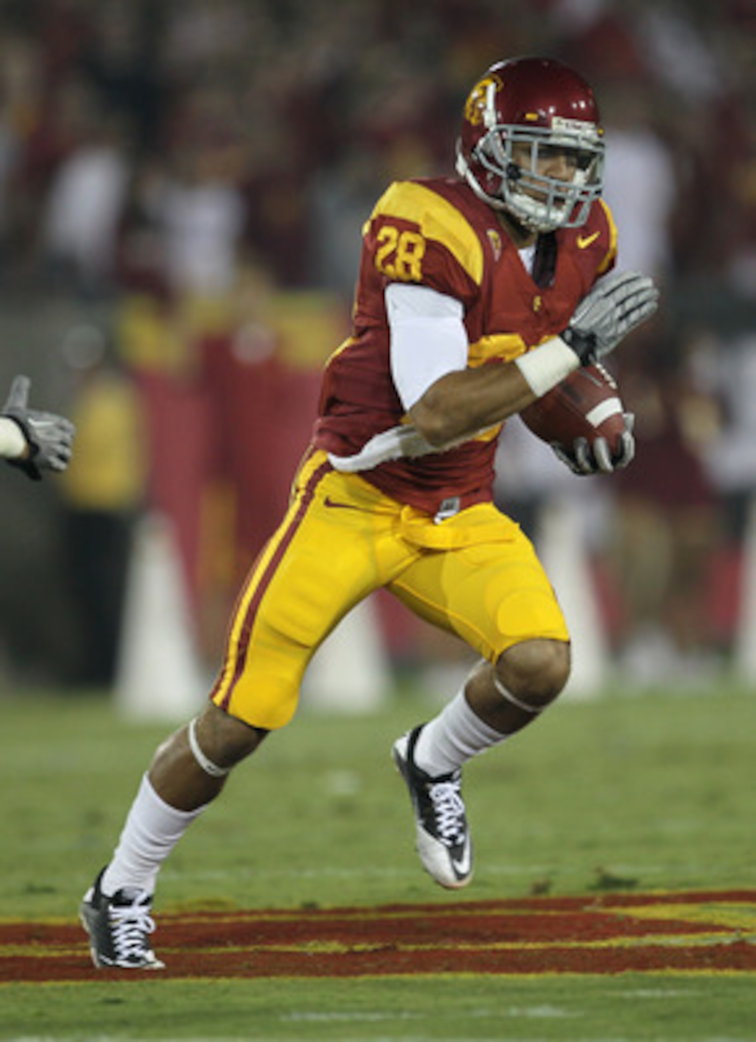 LOS ANGELES, CA - SEPTEMBER 11:  Running back Dillon Baxter #28 of the USC Trojans carries the ball against the Virginia Cavaliers at Los Angeles Memorial Coliseum on September 11, 2010 in Los Angeles, California. USC won 17-14.  (Photo by Stephen Dunn/Ge