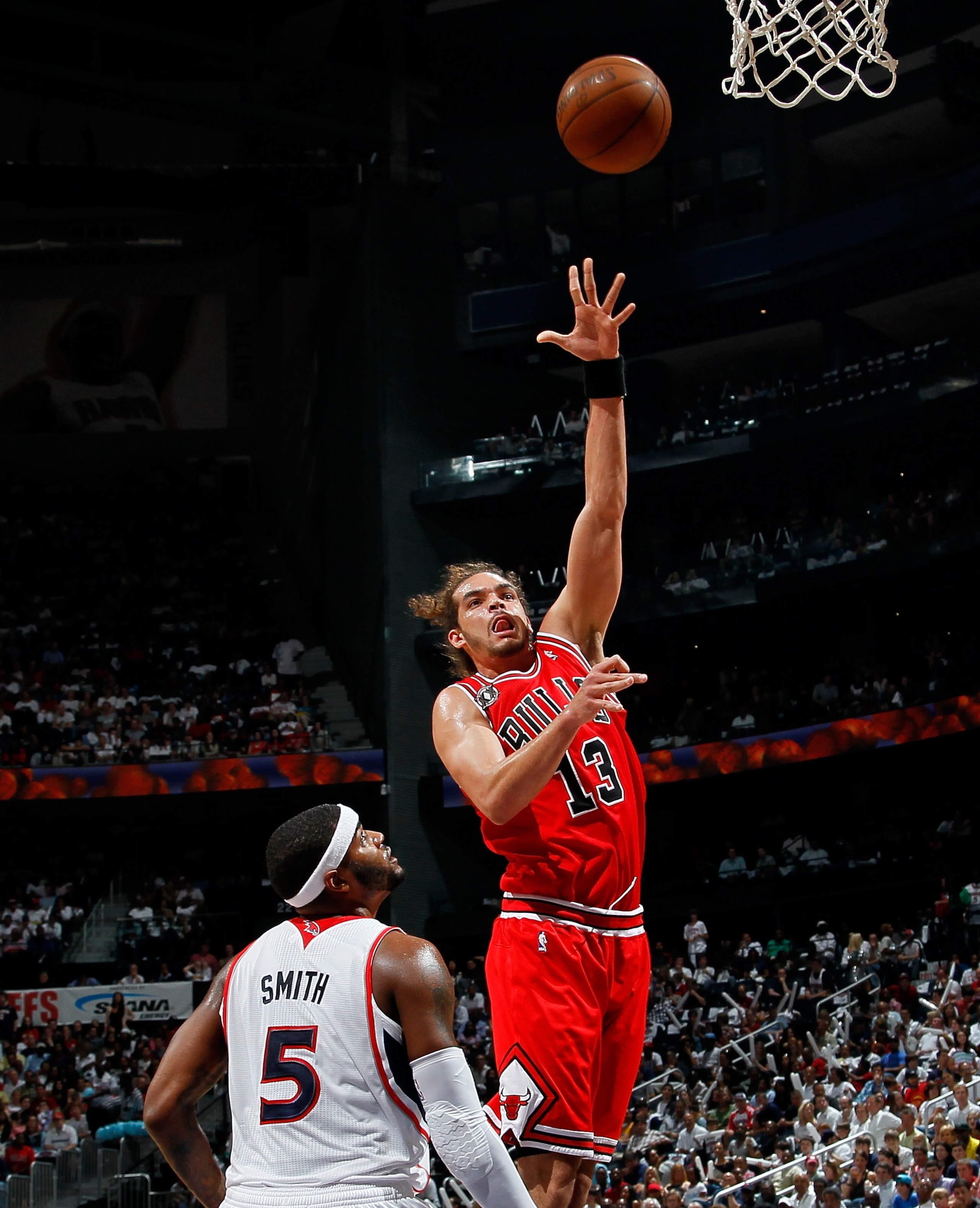 ATLANTA, GA - MAY 08:  Joakim Noah #13 of the Chicago Bulls shoots over Josh Smith #5 of the Atlanta Hawks in Game Four of the Eastern Conference Semifinals in the 2011 NBA Playoffs at Phillips Arena on May 8, 2011 in Atlanta, Georgia.  NOTE TO USER: User