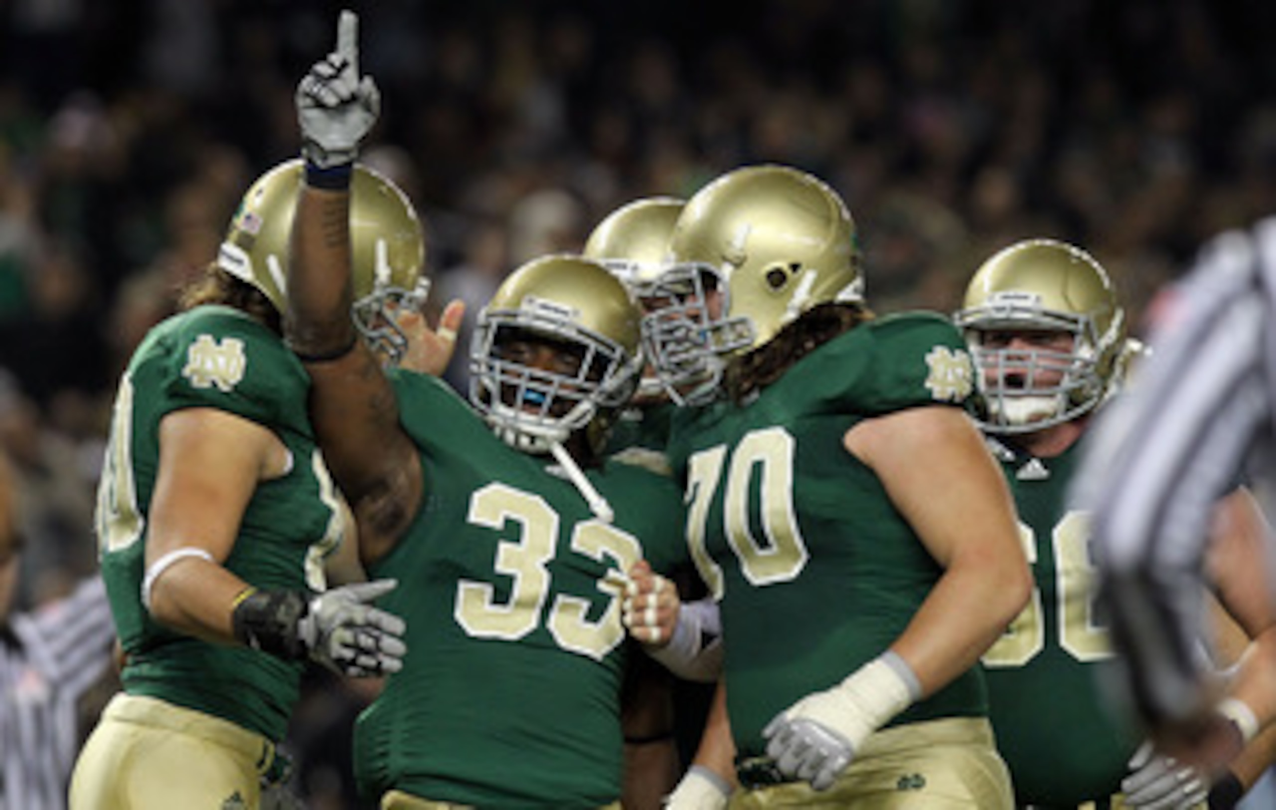 NEW YORK - NOVEMBER 20: Robert Hughes #33 of the Notre Dame Fighting Irish celebrates his touchdown with teammates agianst the Army Black Knights at Yankee Stadium on November 20, 2010 in the Bronx borough of New York City.  (Photo by Nick Laham/Getty Ima