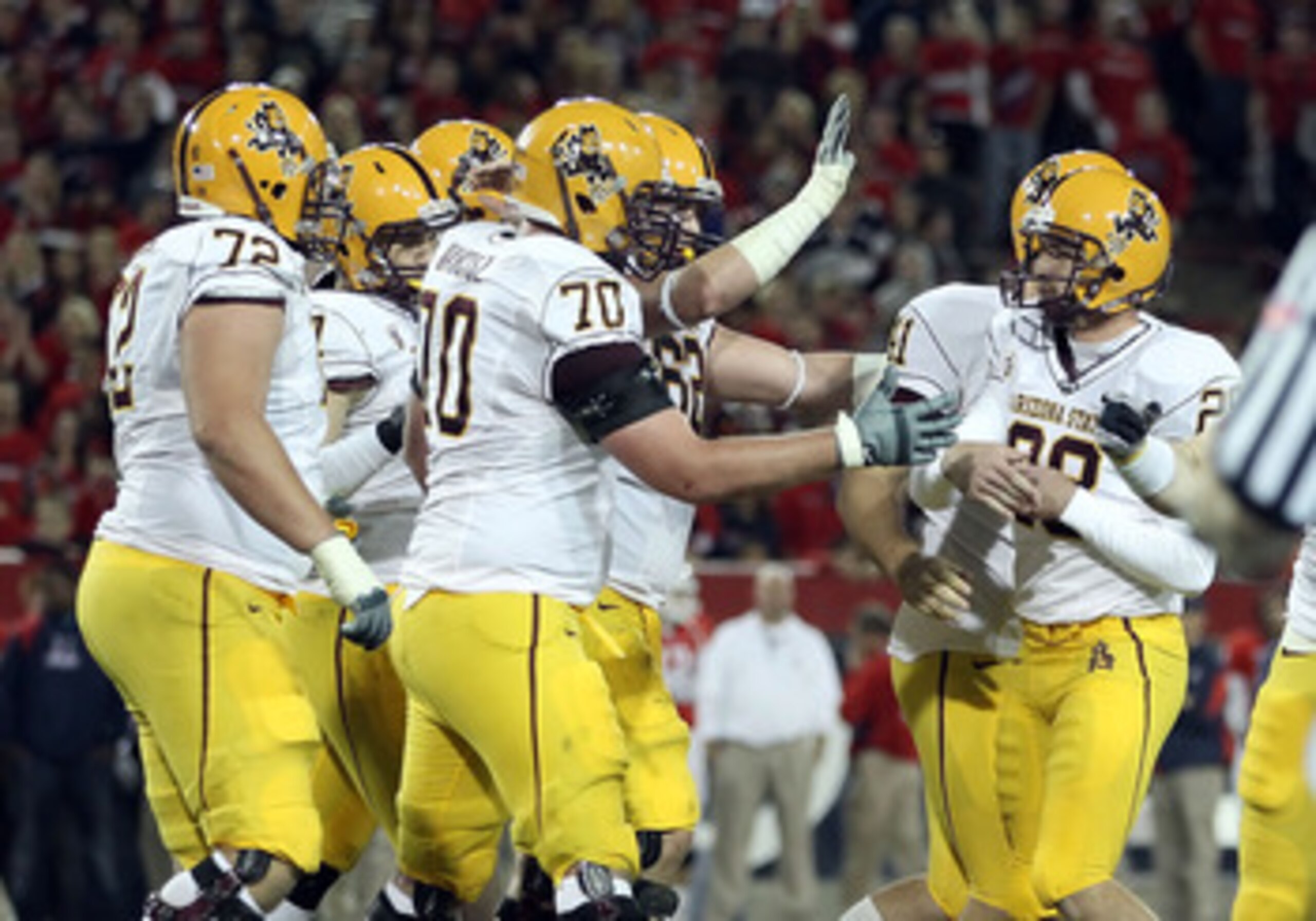 TUCSON, AZ - DECEMBER 02:  Kicker Thomas Weber #26 of the Arizona State Sun Devils is congratulated by teammates after kicking a 36 yard field goal against the Arizona Wildcats during the second quarter of the college football game at Arizona Stadium on D