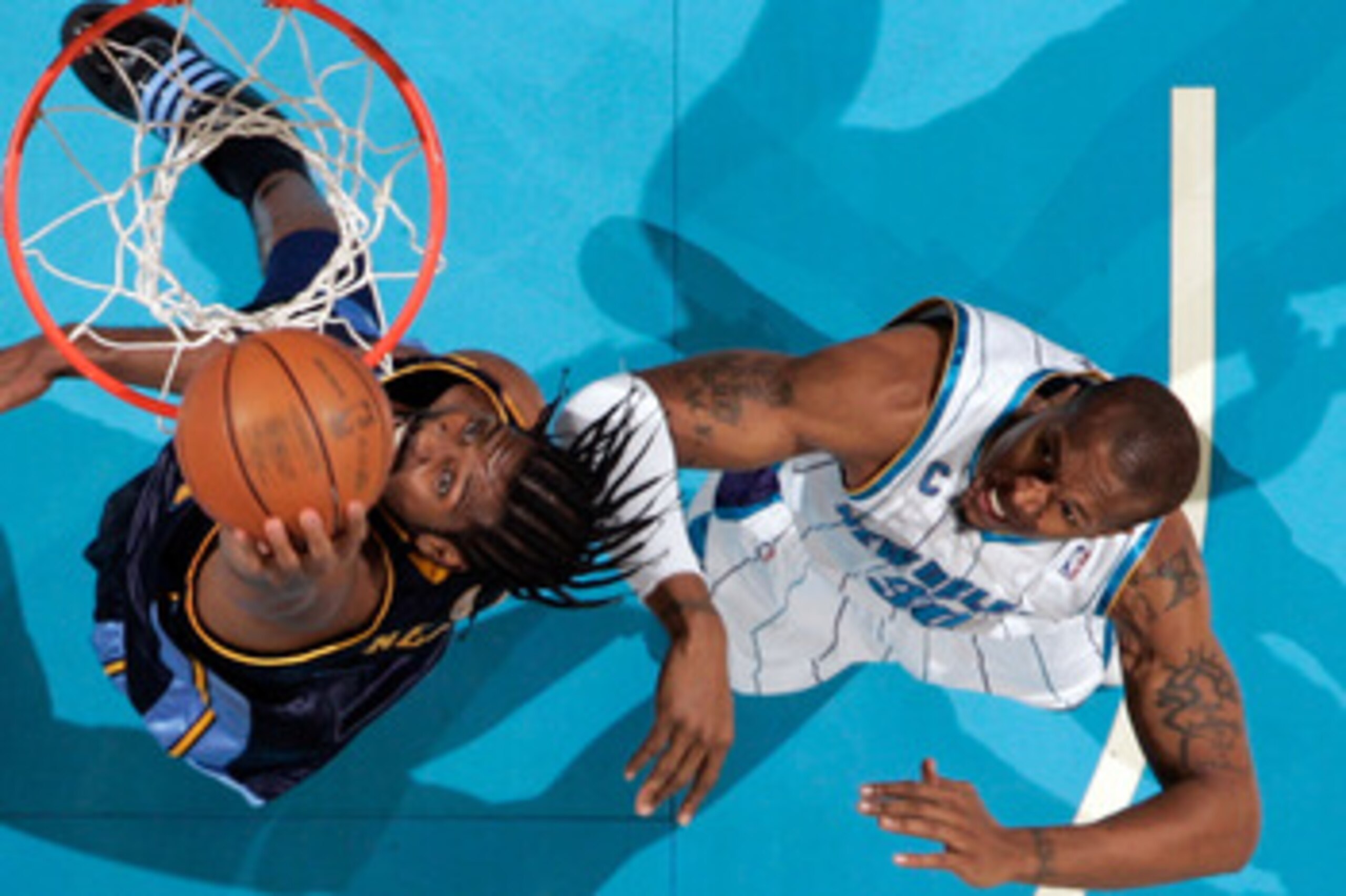 NEW ORLEANS - DECEMBER 18:  Nene #31 of the Denver Nuggets makes a shot over David West #30 of the New Orleans Hornets at New Orleans Arena on December 18, 2009 in New Orleans, Louisiana.  The Hornets defeated the Nuggets 98-92.  NOTE TO USER: User expres