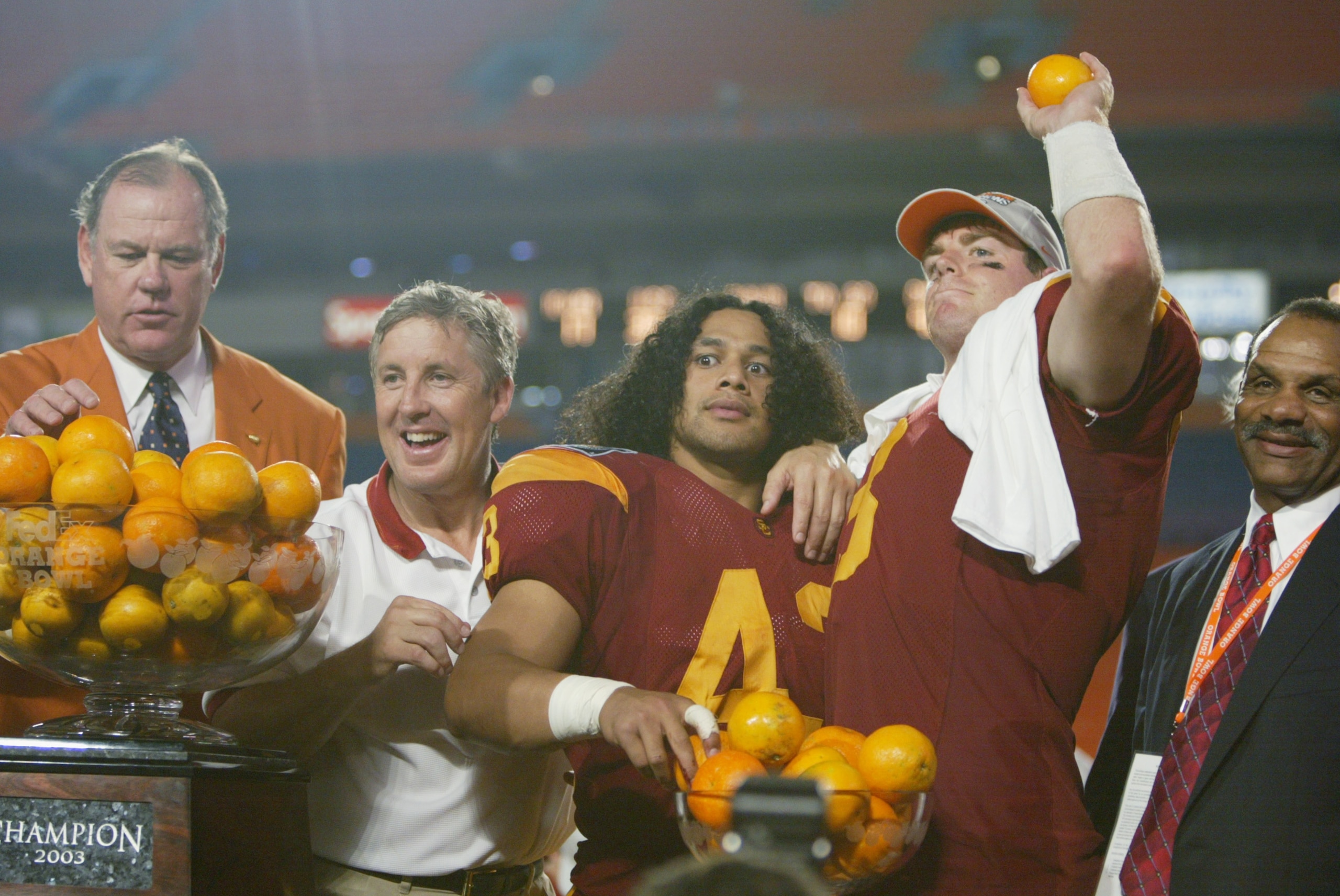 MIAMI - JANUARY 2:  (L-R) Alfonso Cueto, Immediate Past President of the Orange Bowl committee, head coach Pete Carroll, Troy Polamalu #43, Carson Palmer #3 and Athletic Director Mike Garrett of USC celebrate the victory over Iowa in the FedEx Orange Bowl