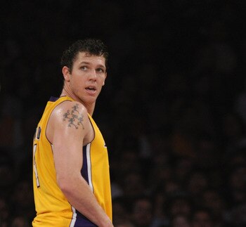 LOS ANGELES, CA - APRIL 12:  Luke Walton #4 of the Los Angeles Lakers looks back at the bench as  Andrew Bynum #17 sits on the floor after an injury during the game against the San Antonio Spurs at Staples Center on April 12, 2011 in Los Angeles, Californ