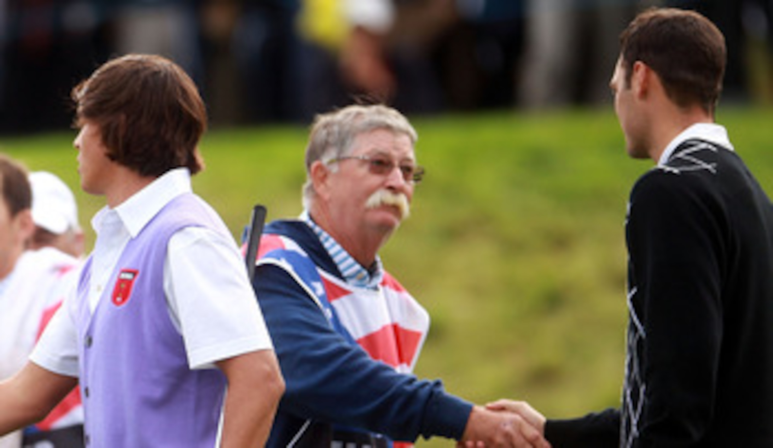 NEWPORT, WALES - OCTOBER 02: Lee Westwood of Europe (L) shakes hands with Rickie Fowler of the USA as caddie Mike Cowan shakes hands with Martin Kaymer on the 18th green after they halved their match during the rescheduled Afternoon Foursome Matches durin