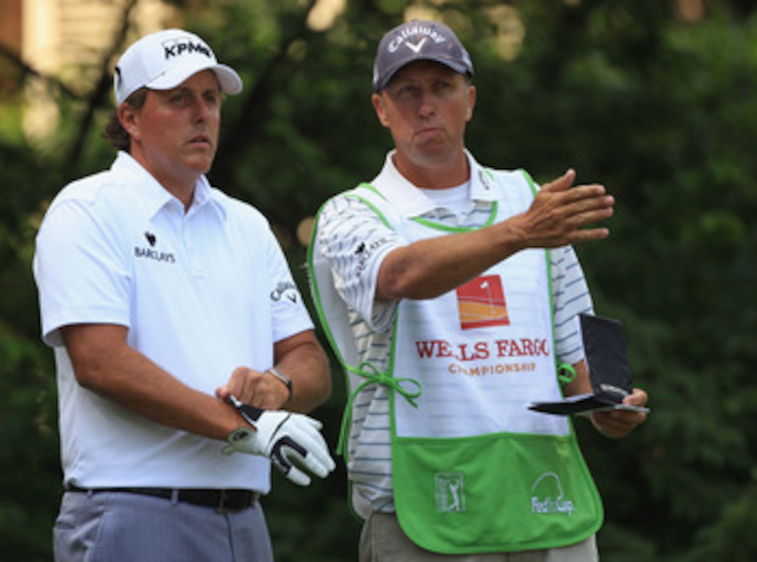 CHARLOTTE, NC - MAY 07:  Phil Mickelson and his caddie Jim Mackay during the third round of the Wells Fargo Championship at Quail Hollow Club on May 7, 2011 in Charlotte, North Carolina.  (Photo by Streeter Lecka/Getty Images)
