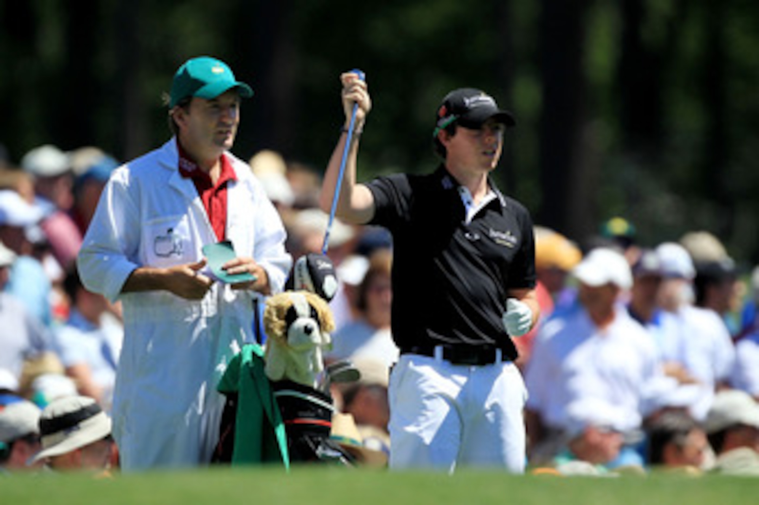 AUGUSTA, GA - APRIL 07:  Rory McIlroy of Northern Ireland pulls a club alongside his caddie JP Fitzgerald on the 12th hole during the first round of the 2011 Masters Tournament at Augusta National Golf Club on April 7, 2011 in Augusta, Georgia.  (Photo by