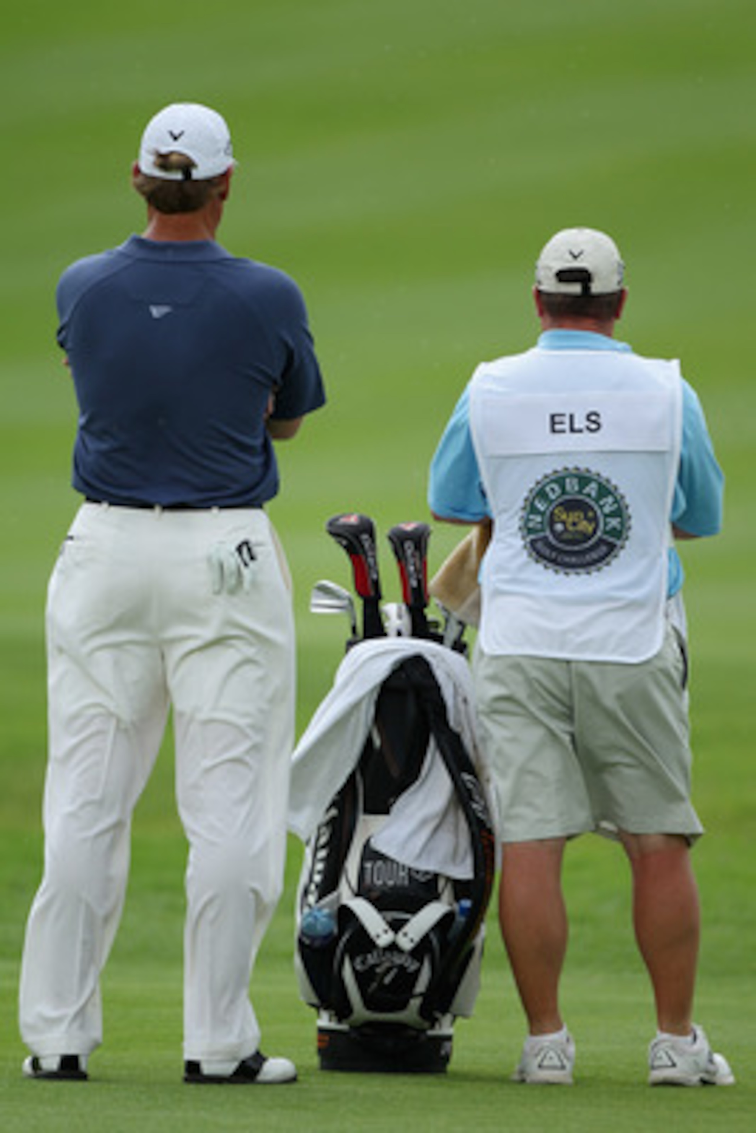 SUN CITY, SOUTH AFRICA - DECEMBER 02:  Ernie Els of South Africa stand with his caddie Ricci Roberts during the first round of the 2010 Nedbank Golf Challenge at the Gary Player Country Club Course  on December 2, 2010 in Sun City, South Africa.  (Photo b