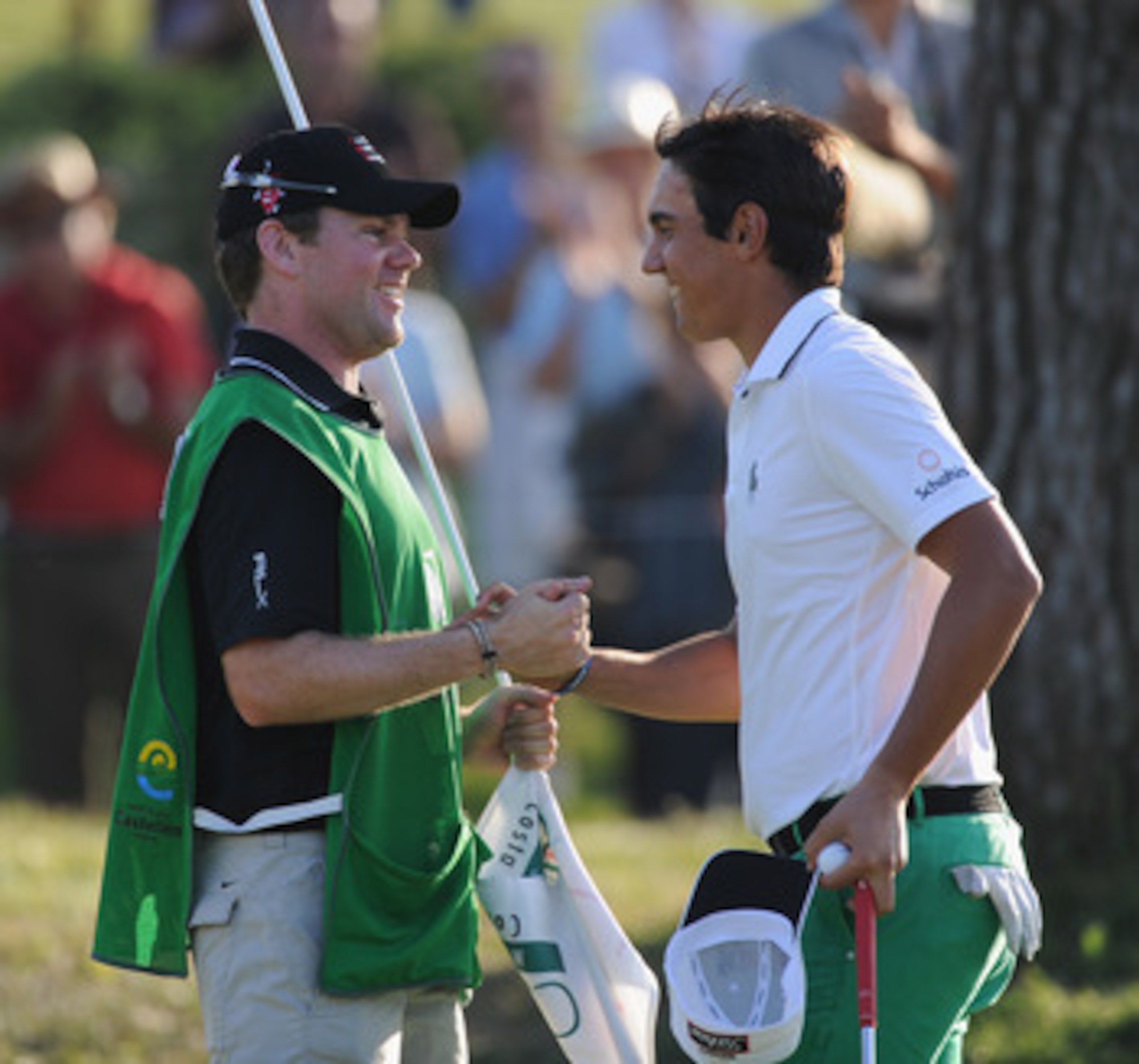 CASTELLON DE LA PLANA, SPAIN - OCTOBER 24:  Matteo Manassero of Italy celebrates with his caddie, Ryan McGuigan on the 18th hole during the final round of the Castello Masters Costa Azahar at the Club de Campo del Mediterraneo on October 24, 2010 in Caste
