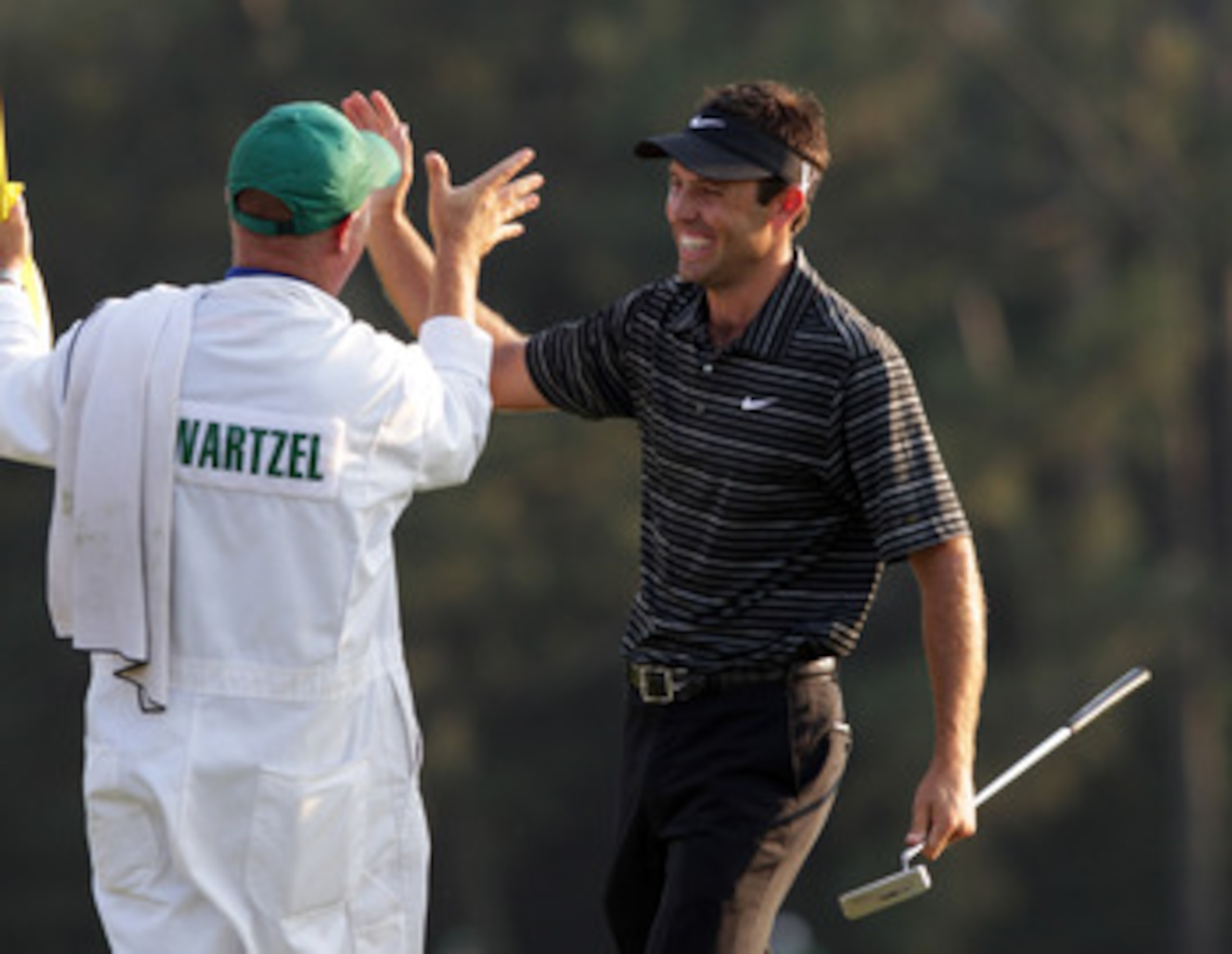 AUGUSTA, GA - APRIL 10:  Charl Schwartzel of South Africa celebrates his birdie on the 18th green with his caddie Greg Hearmon and winning the Masters during the final round of the 2011 Masters Tournament at Augusta National Golf Club on April 10, 2011 in