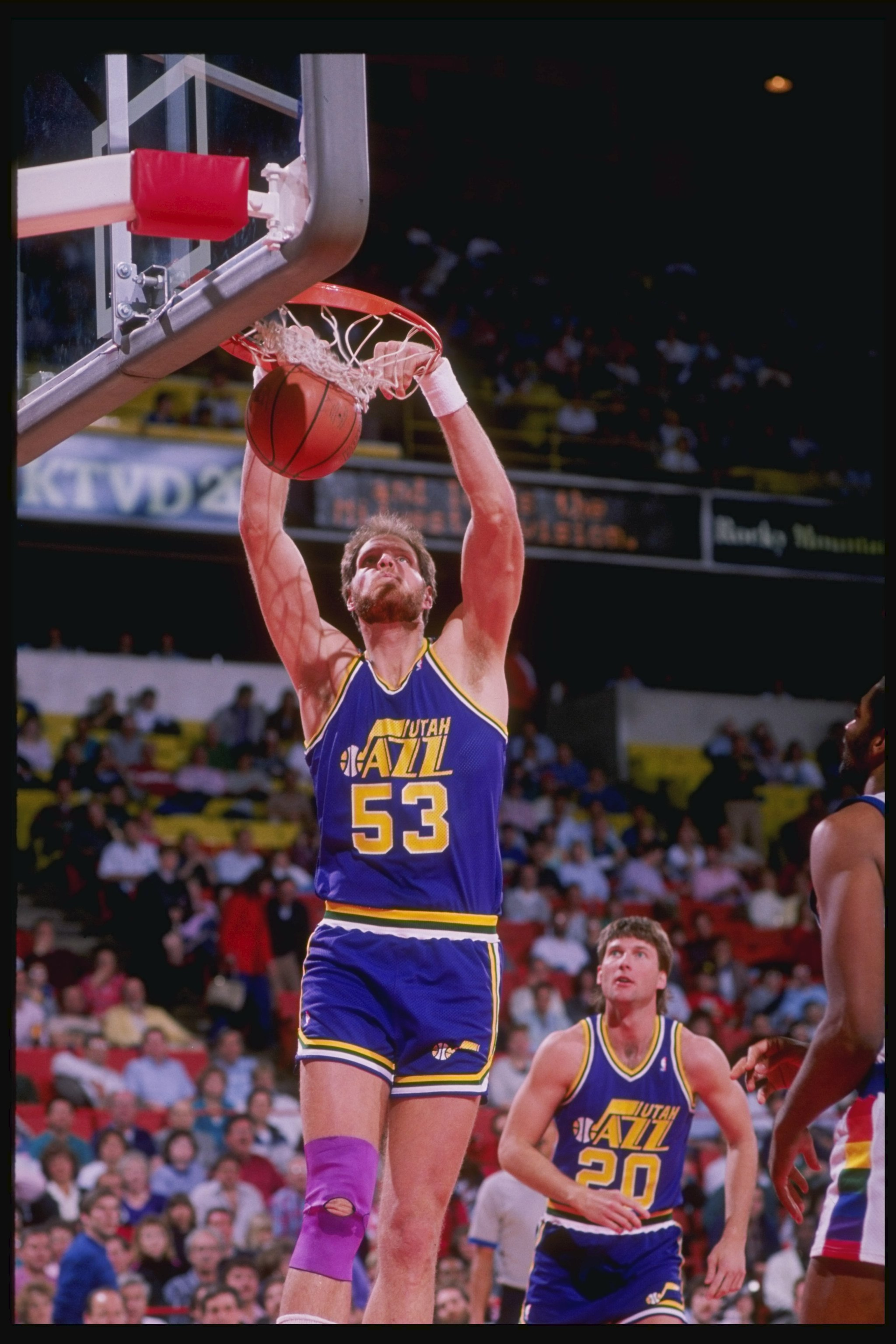1989-1990: Center Mark Eaton of the Utah Jazz slam dunks as teammate guard Bobby Hansen (right) looks on during a game against the Denver Nuggets at McNichols Arena in Denver, Colorado. Mandatory Credit: Tim de Frisco /Allsport 1989-1990: Center Mark Eaton of the Utah Jazz slam dunks as teammate guard Bobby Hansen (right) looks on during a game against the Denver Nuggets at McNichols Arena in Denver, Colorado. Mandatory Credit: Tim de Frisco /Allsport