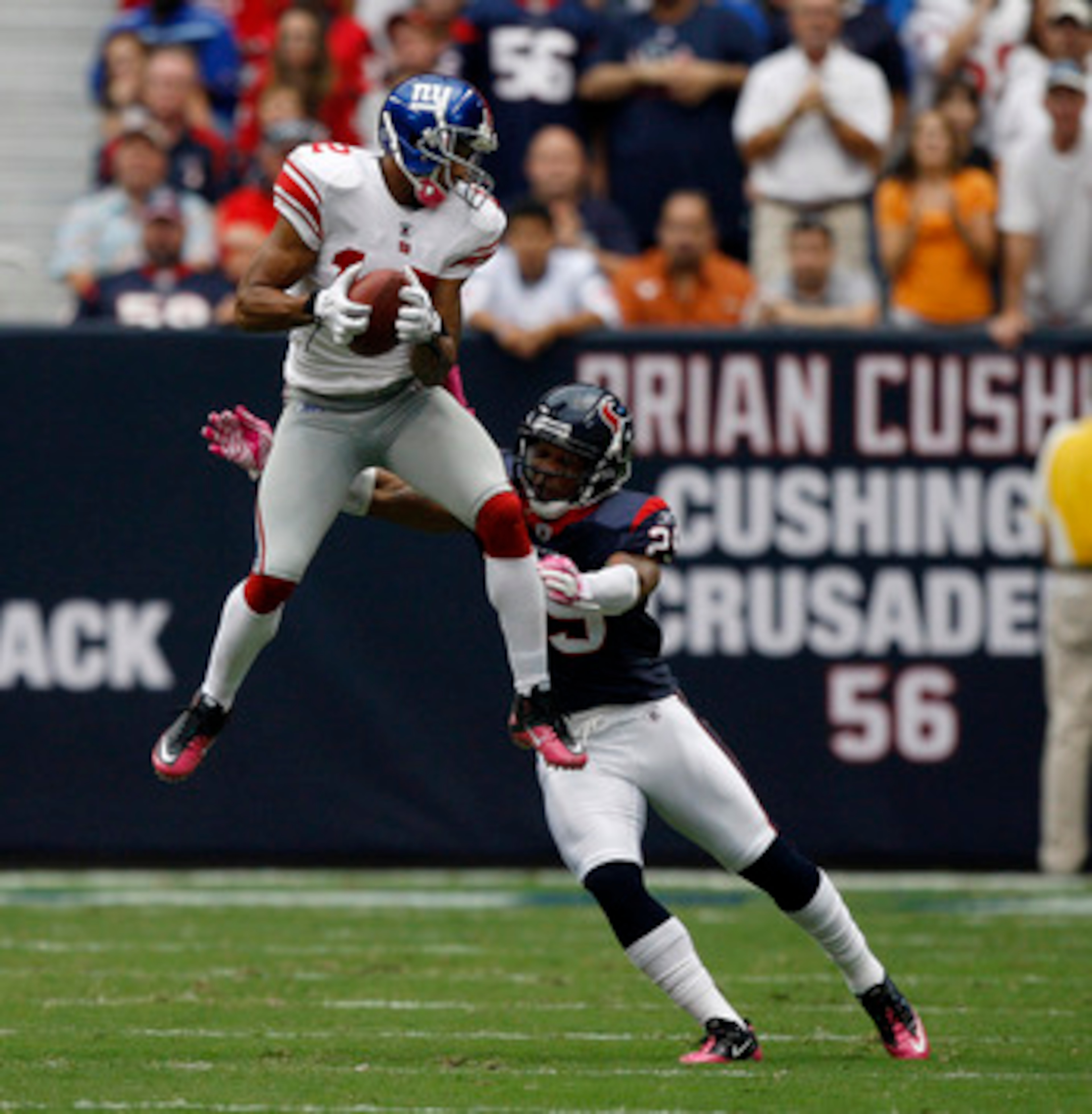HOUSTON - OCTOBER 10:  Wide receiver Steve Smith #12 of the New York Giants goes up high in front of cornerback Glover Quin #29 of the Houston Texans in the first half at Reliant Stadium on October 10, 2010 in Houston, Texas.  (Photo by Bob Levey/Getty Im