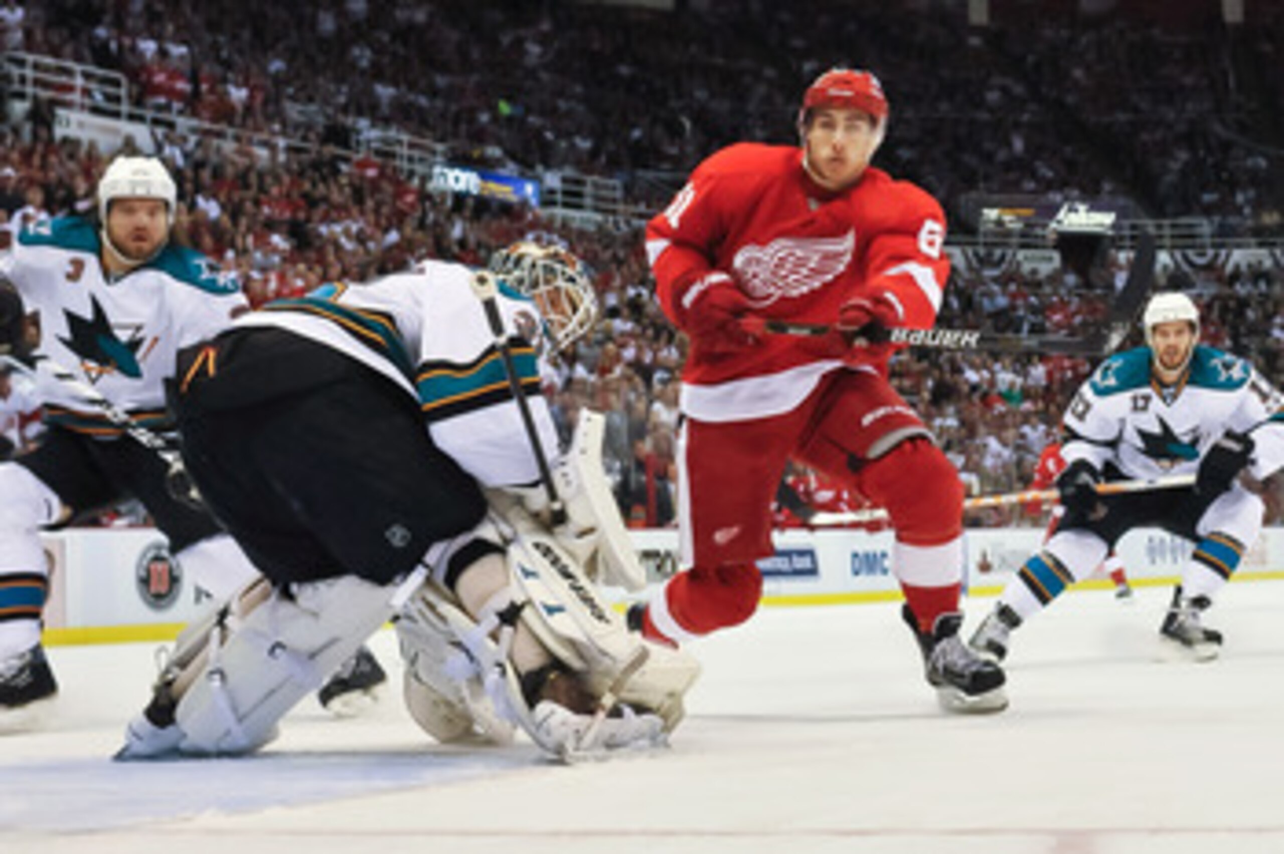 DETROIT - MAY 4: Valtteri Filppula #51 of the Detroit Red Wings skates past goaltender Antti Niemi #31 of the San Jose Sharks in Game Three of the Western Conference Semifinals during the 2011 NHL Stanley Cup Playoffs on May 4, 2011 at Joe Louis Arena in 
