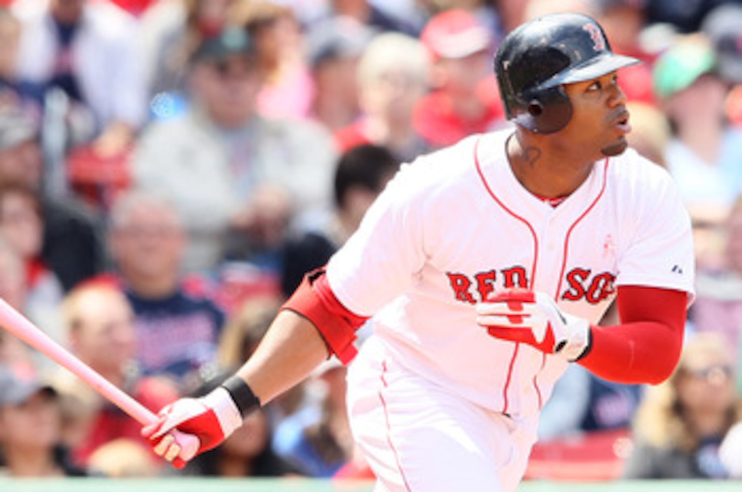 BOSTON, MA - MAY 08:  Carl Crawford #13 of the Boston Red Sox hits a triple as Drew Butera #41 of the Minnesota Twins catches on May 8, 2011 at Fenway Park in Boston, Massachusetts. The Minnesota Twins and the Boston Red Sox wore pink and used pink bats i