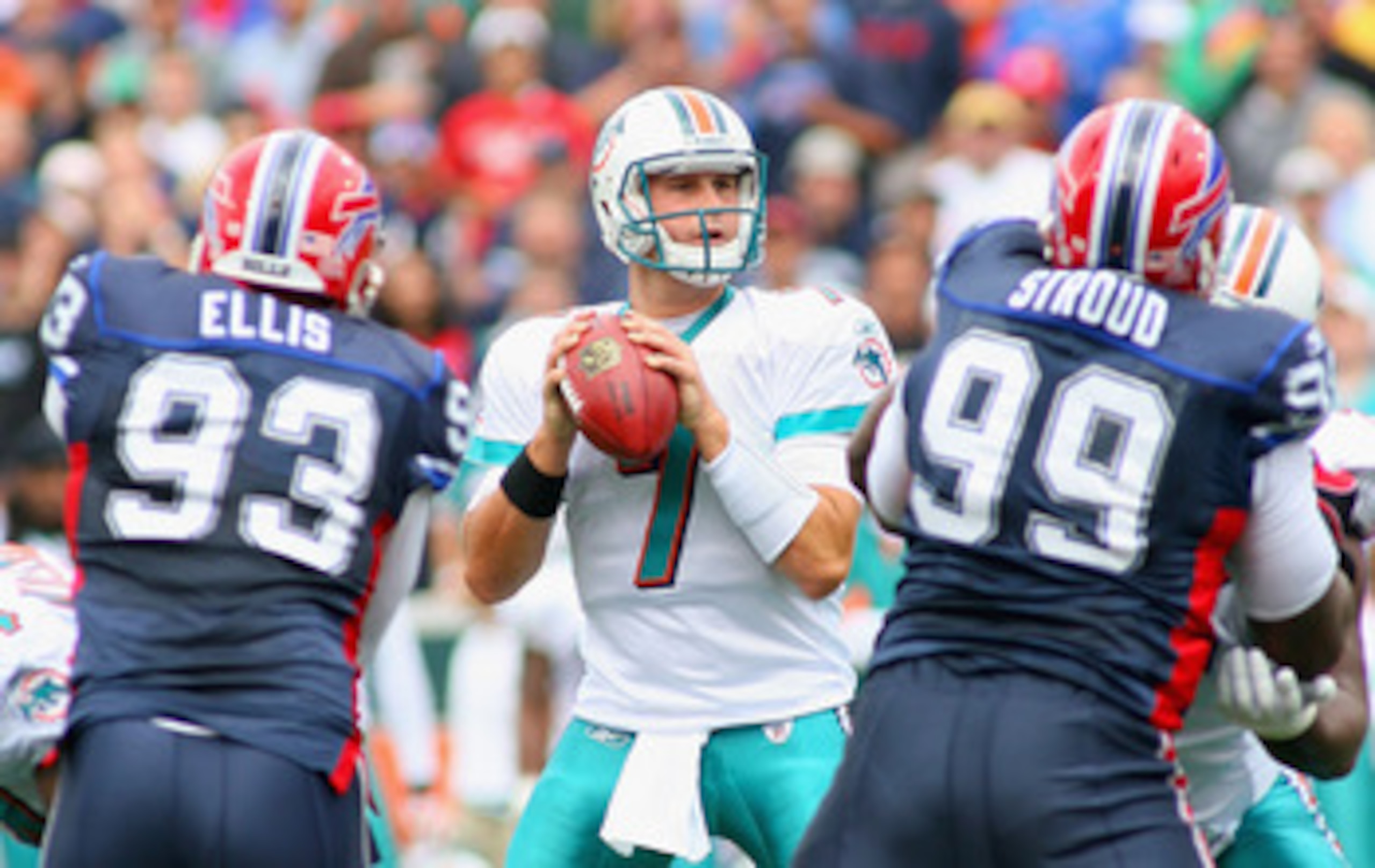 ORCHARD PARK, NY - SEPTEMBER 12: Chad Henne #7 of the Miami Dolphins readies to pass as Chris Ellis #93 and Marcus Stroud #99 of  the Buffalo Bills rush during the NFL season opener at Ralph Wilson Stadium on September 12, 2010 in Orchard Park, New York.