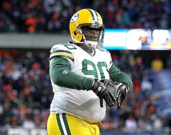CHICAGO, IL - JANUARY 23:  B.J. Raji #90 of the Green Bay Packers reacts after scoring on a 18-yard interception return for a touchdown in the fourth quarter against the Chicago Bears in the NFC Championship Game at Soldier Field on January 23, 2011 in Ch
