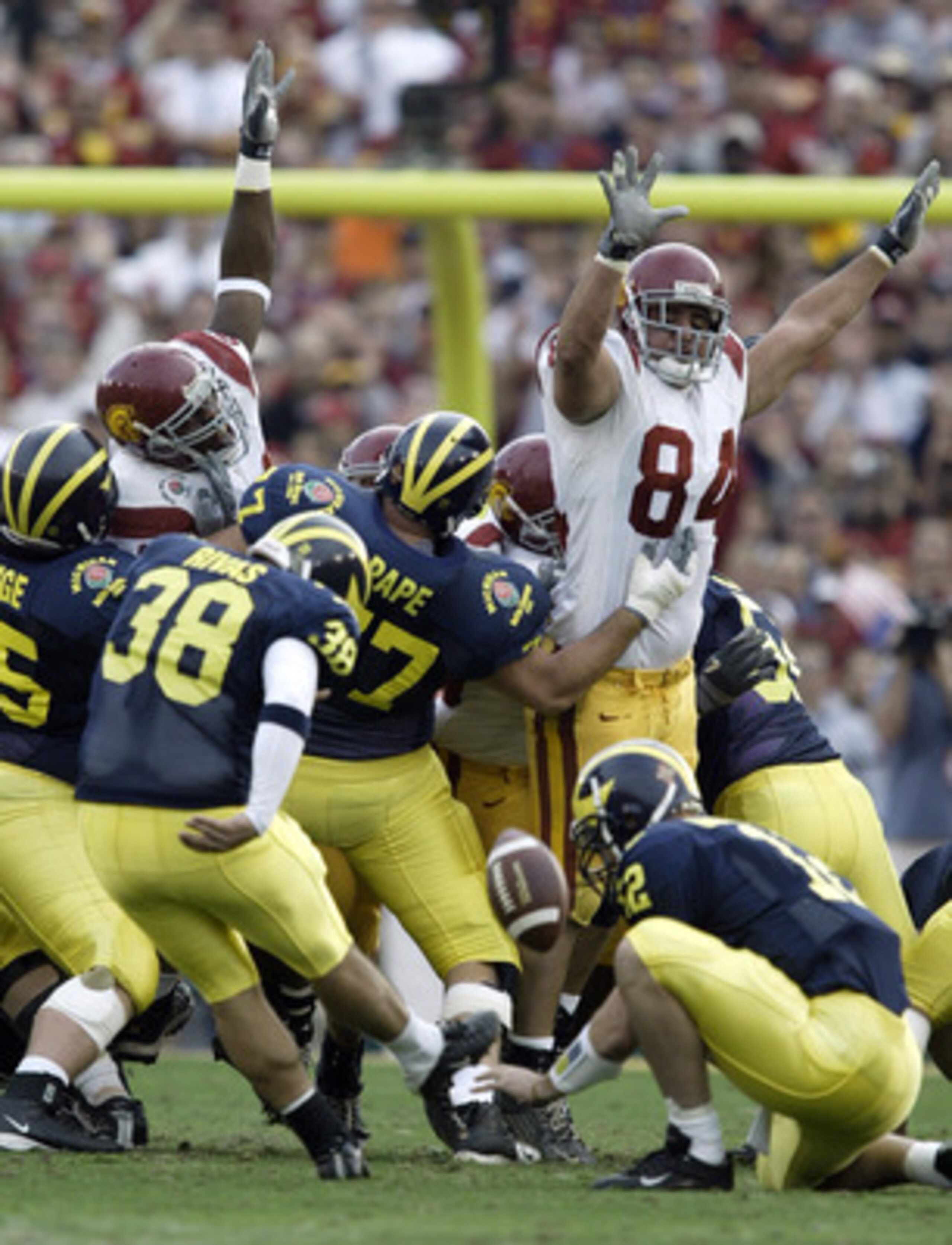 PASADENA, CA - JANUARY 1: Placekicker Garrett Rivas #38 of the Michigan Wolverines attempts a field goal which was blocked by defensive tackle Shaun Cody #84 of the USC Trojans during the 2004 Rose Bowl game on January 1, 2004 at the Rose Bowl in Pasaden PASADENA, CA - JANUARY 1: Placekicker Garrett Rivas #38 of the Michigan Wolverines attempts a field goal which was blocked by defensive tackle Shaun Cody #84 of the USC Trojans during the 2004 Rose Bowl game on January 1, 2004 at the Rose Bowl in Pasaden