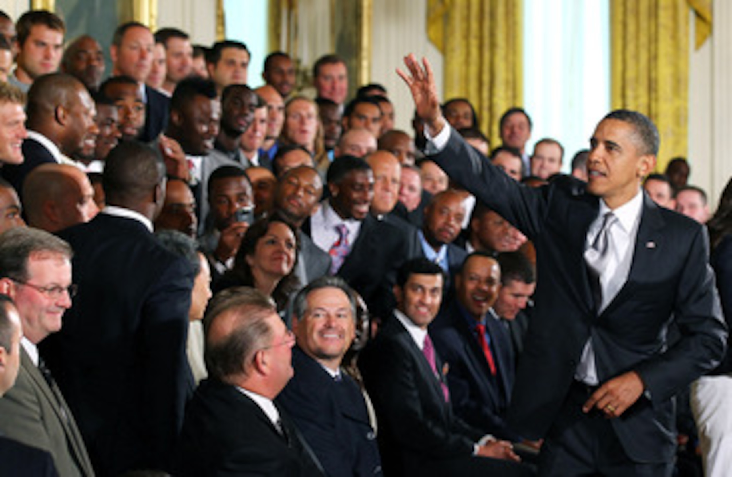 WASHINGTON - AUGUST 09:  U.S. President Barack Obama (R) greets members of the New Orleans Saints during a reception for the 2010 National Football League Super Bowl champions in the East Room of the White House August 9, 2010 in Washington, DC. The Saint