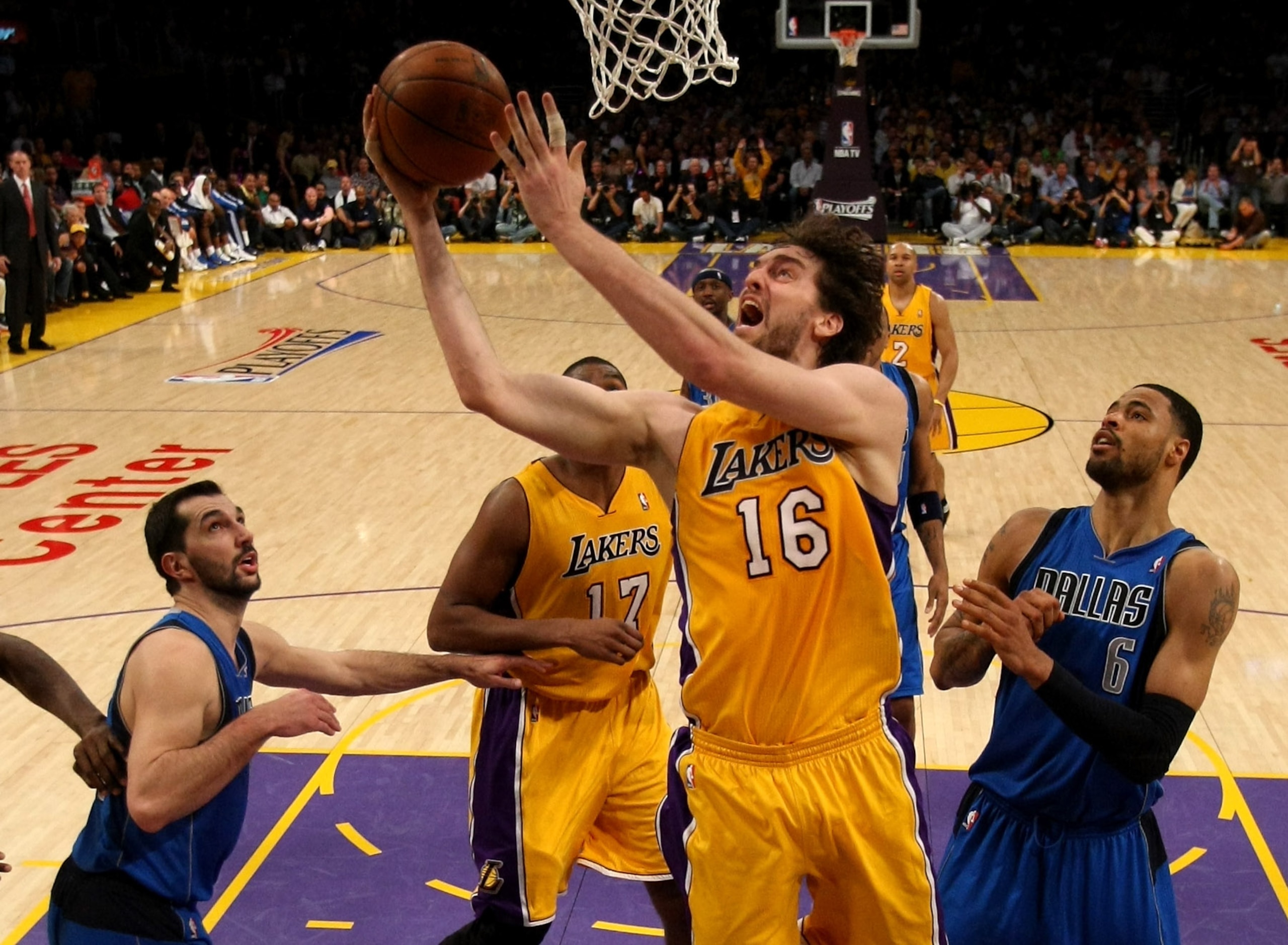 LOS ANGELES, CA - MAY 04:  Pau Gasol #16 of the Los Angeles Lakers goes up for a shot between Peja Stojakovic #16 and Tyson Chandler #6 of the Dallas Mavericks in Game Two of the Western Conference Semifinals in the 2011 NBA Playoffs at Staples Center on
