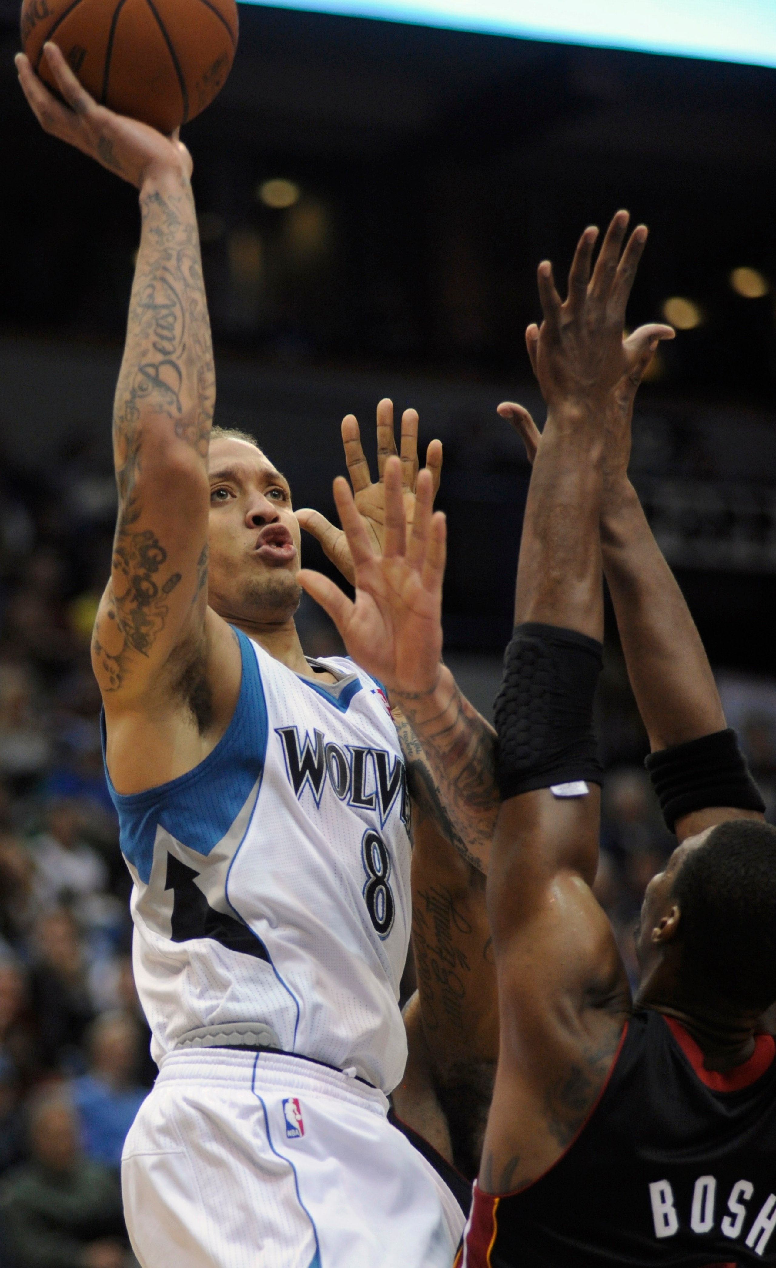 MINNEAPOLIS, MN - APRIL 1: Michael Beasley #8 of Minnesota Timberwolves shoots against Chris Bosh #1 of the Miami Heat during the second half of a basketball game at Target Center on April 1, 2011 in Minneapolis, Minnesota. The Heat defeated the Timberwol