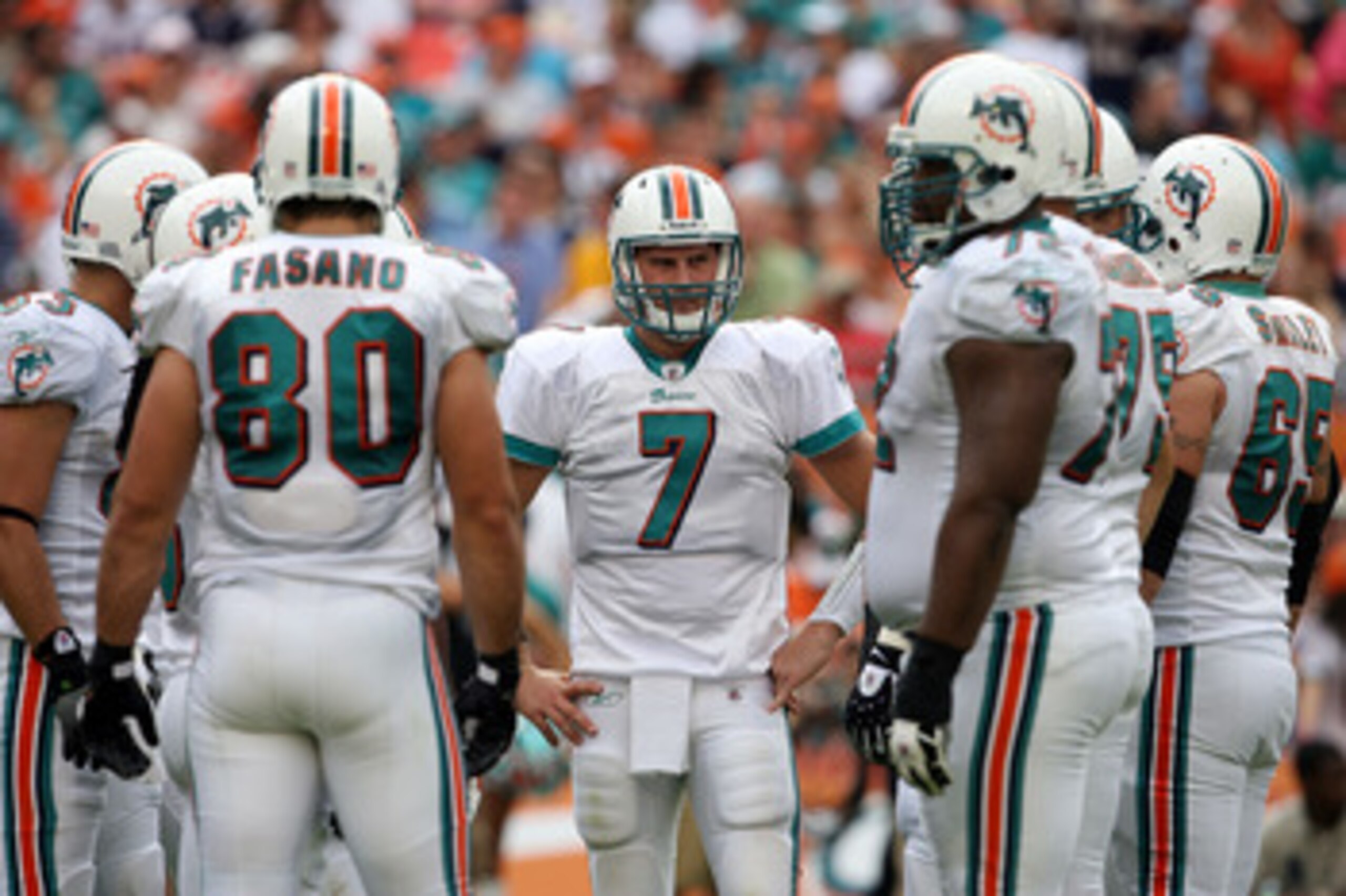 MIAMI - DECEMBER 06:  Quarterback Chad Henne #7 of the Miami Dolphins waits to call the play in the huddle while taking on the New England Patriots at Land Shark Stadium on December 6, 2009 in Miami, Florida. The Dolphins defeated the Patriots 22-21.  (Ph