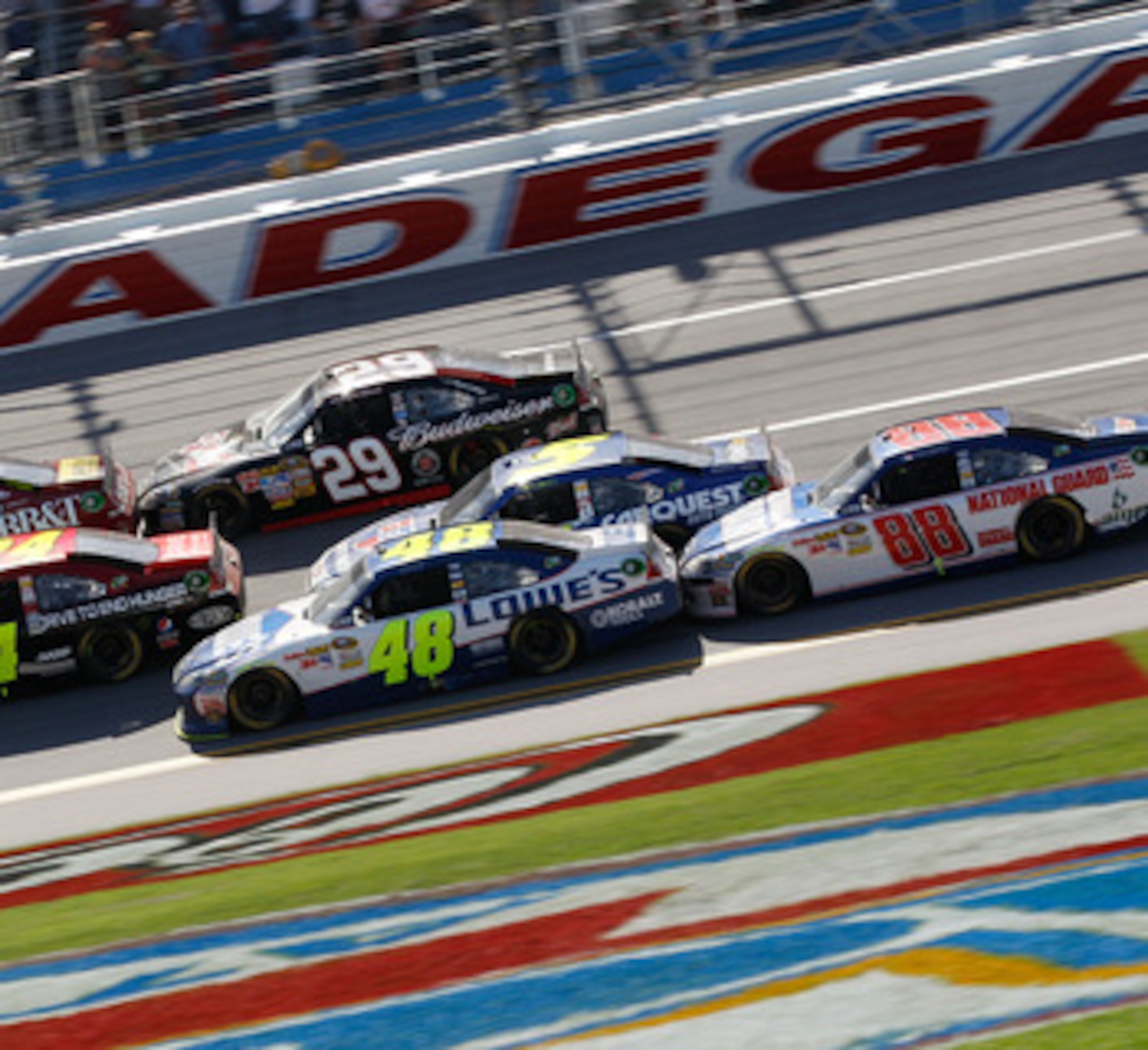 TALLADEGA, AL - APRIL 17:  Clint Bowyer, driver of the #33 BB&T Chevrolet, Jeff Gordon, driver of the #24 Drive to End Hunger/AARP Chevrolet, and Jimmie Johnson, driver of the #48 Lowe's Chevrolet, lead Kevin Harvick, driver of the #29 Budweiser Chevrolet