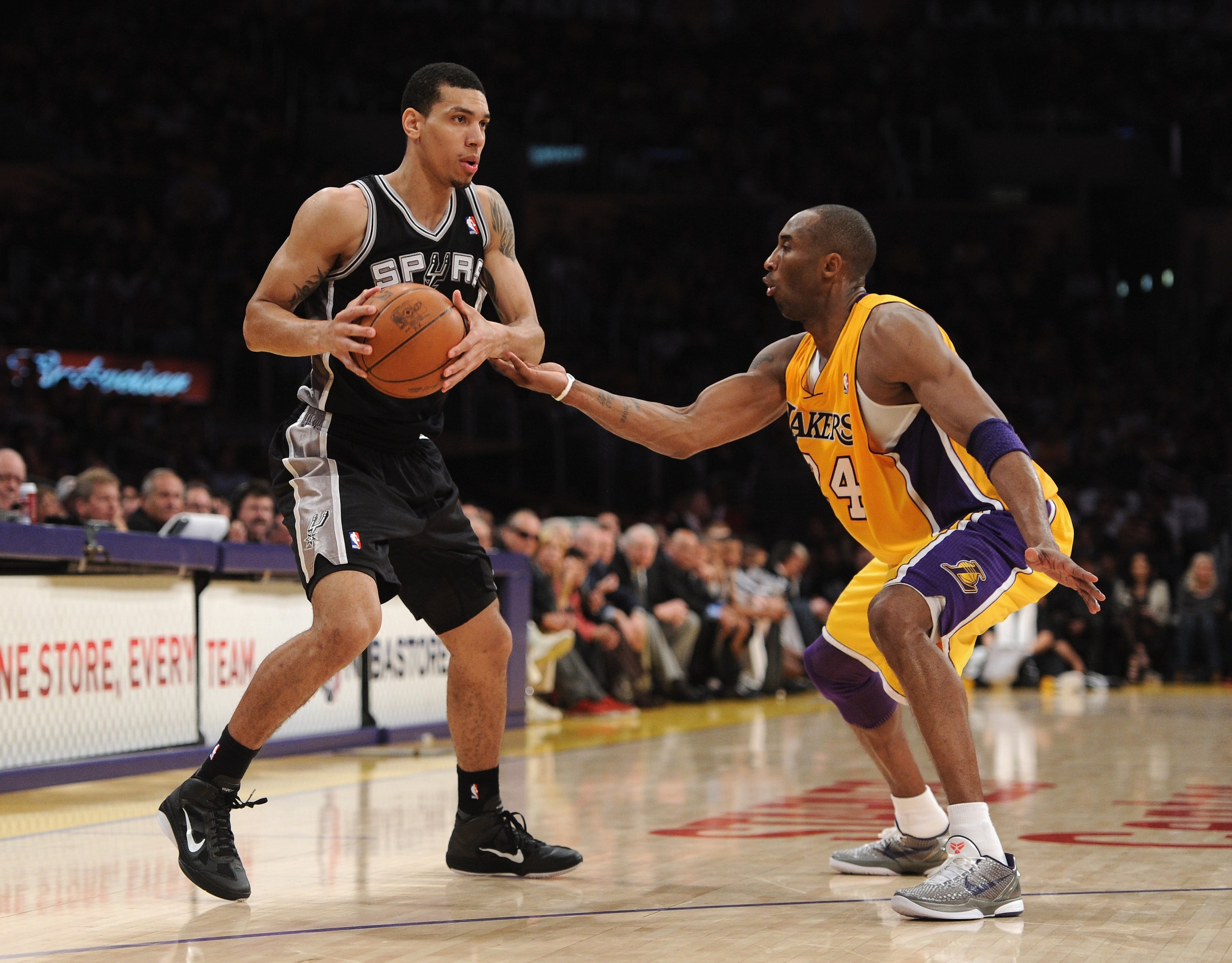 LOS ANGELES, CA - APRIL 12:  Danny Green #4 of the San Antonio Spurs looks to pass in front of Kobe Bryant #23 of the Los Angeles Lakers at Staples Center on April 12, 2011 in Los Angeles, California.  NOTE TO USER: User expressly acknowledges and agrees
