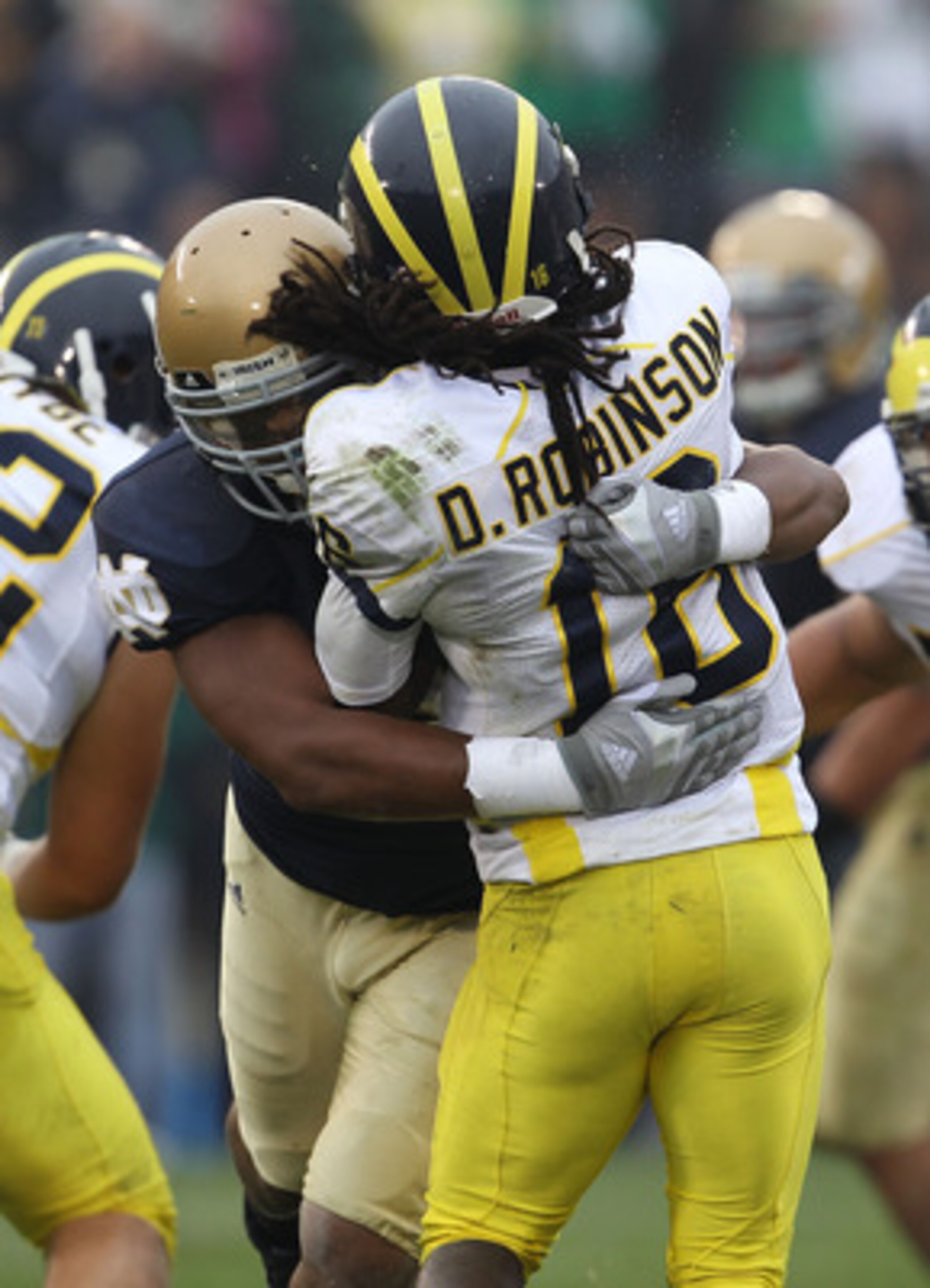 SOUTH BEND, IN - SEPTEMBER 11: Brian Smith #58 of the Notre Dame Fighting Irish hits Denard Robinson #16 of the Michigan Wolverines at Notre Dame Stadium on September 11, 2010 in South Bend, Indiana. Michigan defeated Notre Dame 28-24.  (Photo by Jonathan