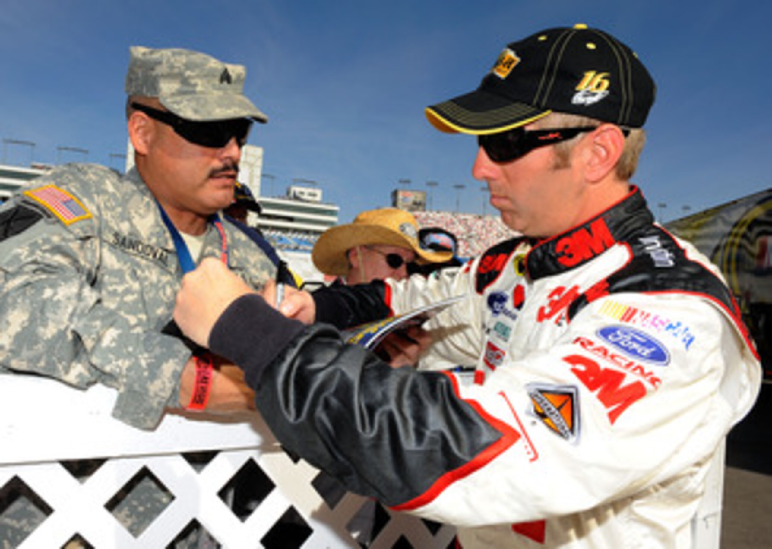 LAS VEGAS, NV - MARCH 05:  Greg Biffle, driver of the #16 3M Post-it Ford, signs his autograph for a fan during practice for the NASCAR Sprint Cup Series Kobalt Tools 400 at Las Vegas Motor Speedway on March 5, 2011 in Las Vegas, Nevada.  (Photo by Jared