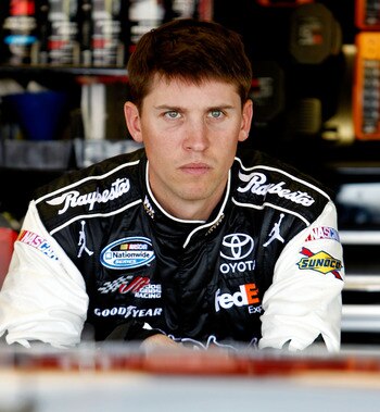 DARLINGTON, SC - MAY 06:  Denny Hamlin, driver of the #11 Sport Clips Toyota, stands in the garage during practice for the NASCAR Sprint Cup Series SHOWTIME Southern 500 at Darlington Raceway on May 6, 2011 in Darlington, South Carolina.  (Photo by Jeff Z