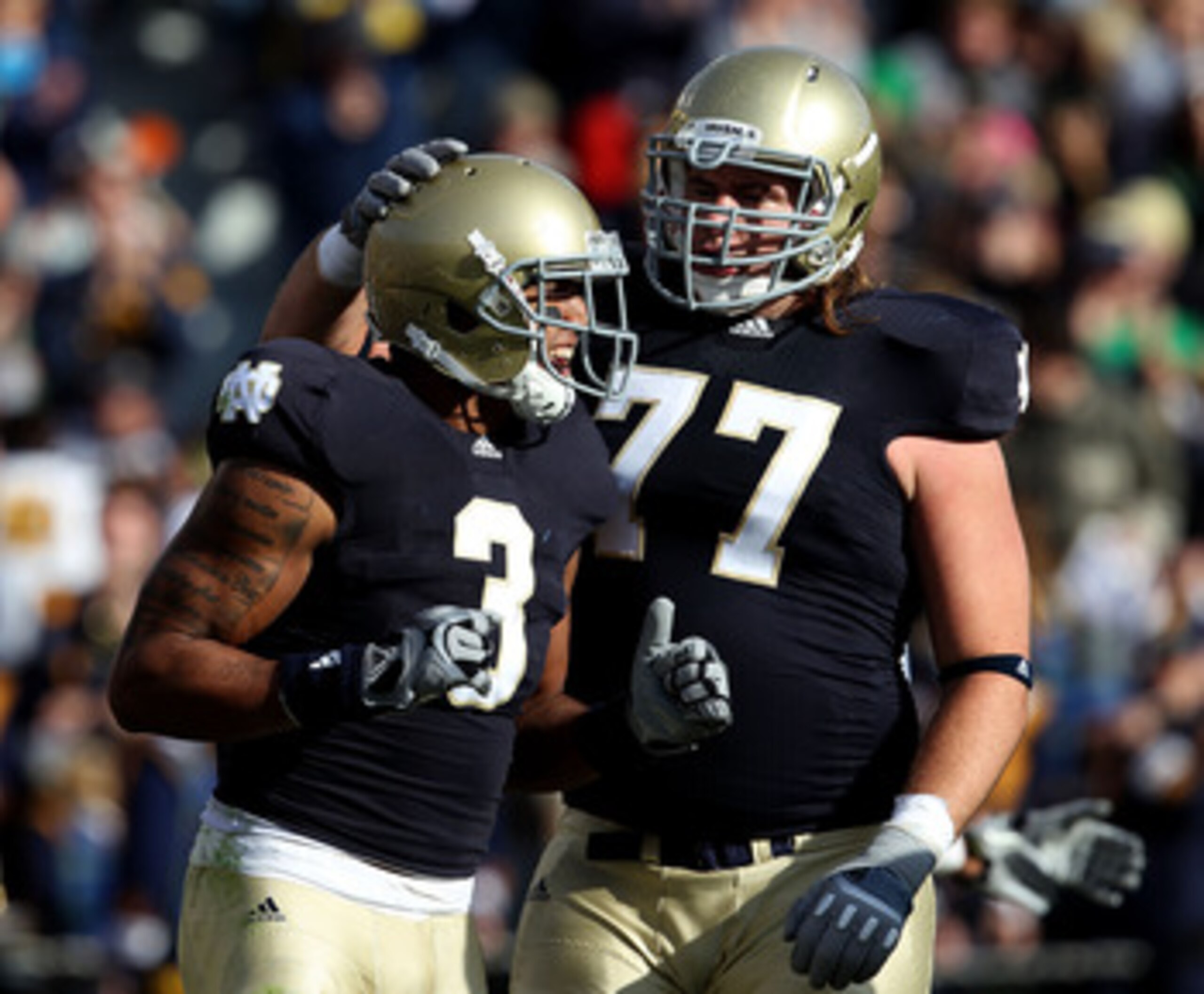 SOUTH BEND, IN - OCTOBER 30: Michael Floyd #3 and Matt Romine #77 of the Notre Dame Fighting Irish celebrate Floyd's touchdown catch against the Tulsa Golden Hurricane at Notre Dame Stadium on October 30, 2010 in South Bend, Indiana. (Photo by Jonathan Da
