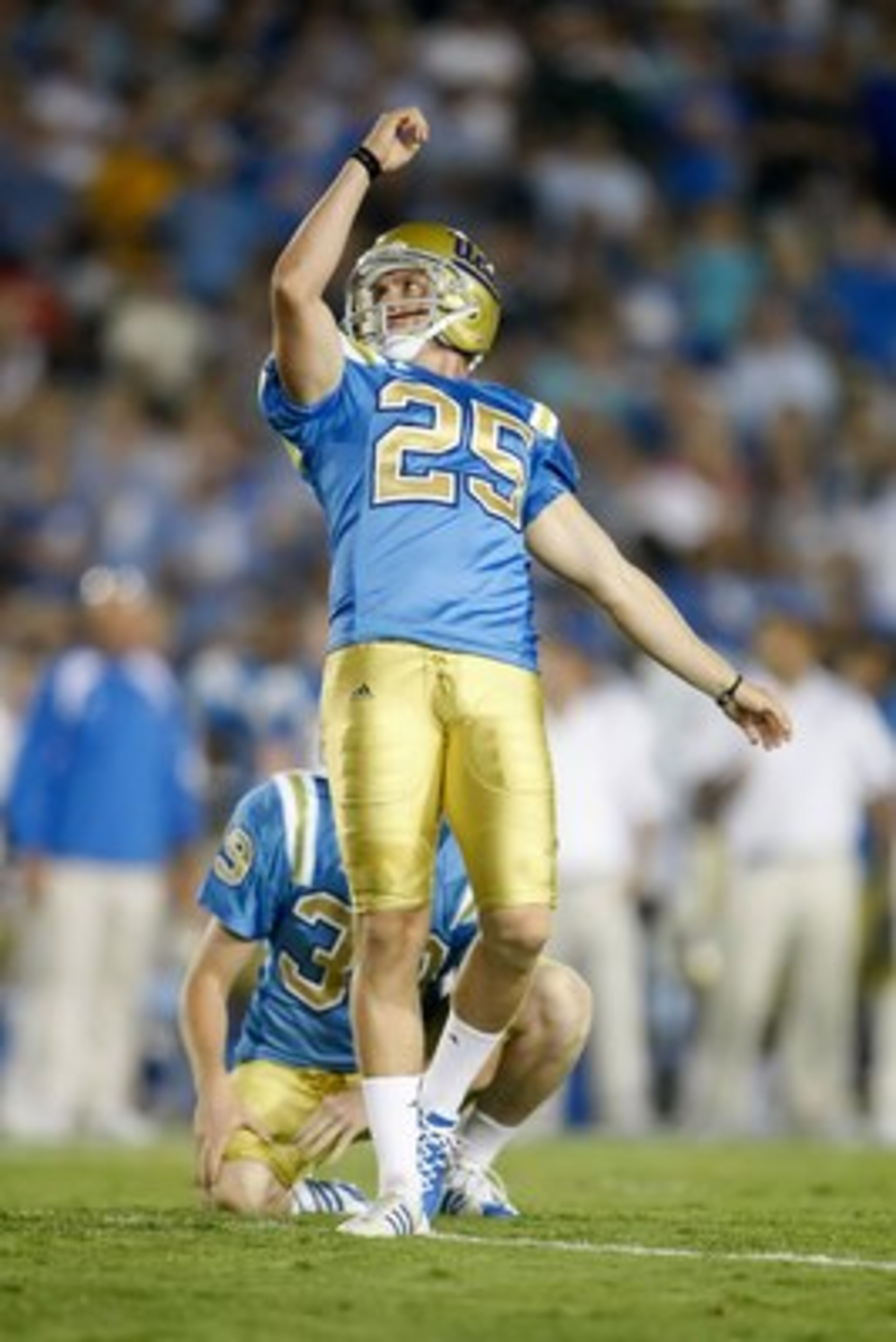 PASADENA, CA - SEPTEMBER 19:  Kai Forbath #25 of the UCLA Bruins kicks as Danny Rees #39 holds against the Kansas State Wildcats at the Rose Bowl on September 19, 2009 in Pasadena, California. UCLA defeated Kansas State 23-9.  (Photo by Jeff Gross/Getty I