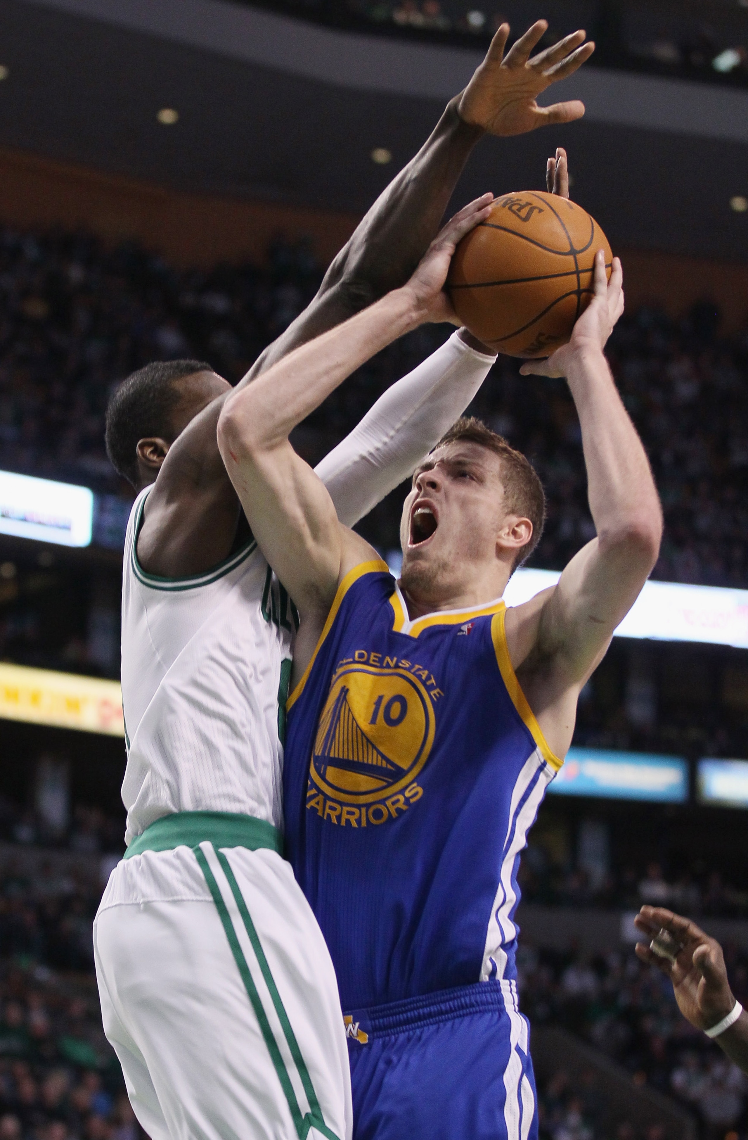 BOSTON, MA - MARCH 04: David Lee #10 of the Golden State Warriors takes a shot as Jeff Green #8 of the Boston Celtics defends on March 4, 2011 at the TD Garden in Boston, Massachusetts.  The Celtics defeated the Warriors 107-103. NOTE TO USER: User expres