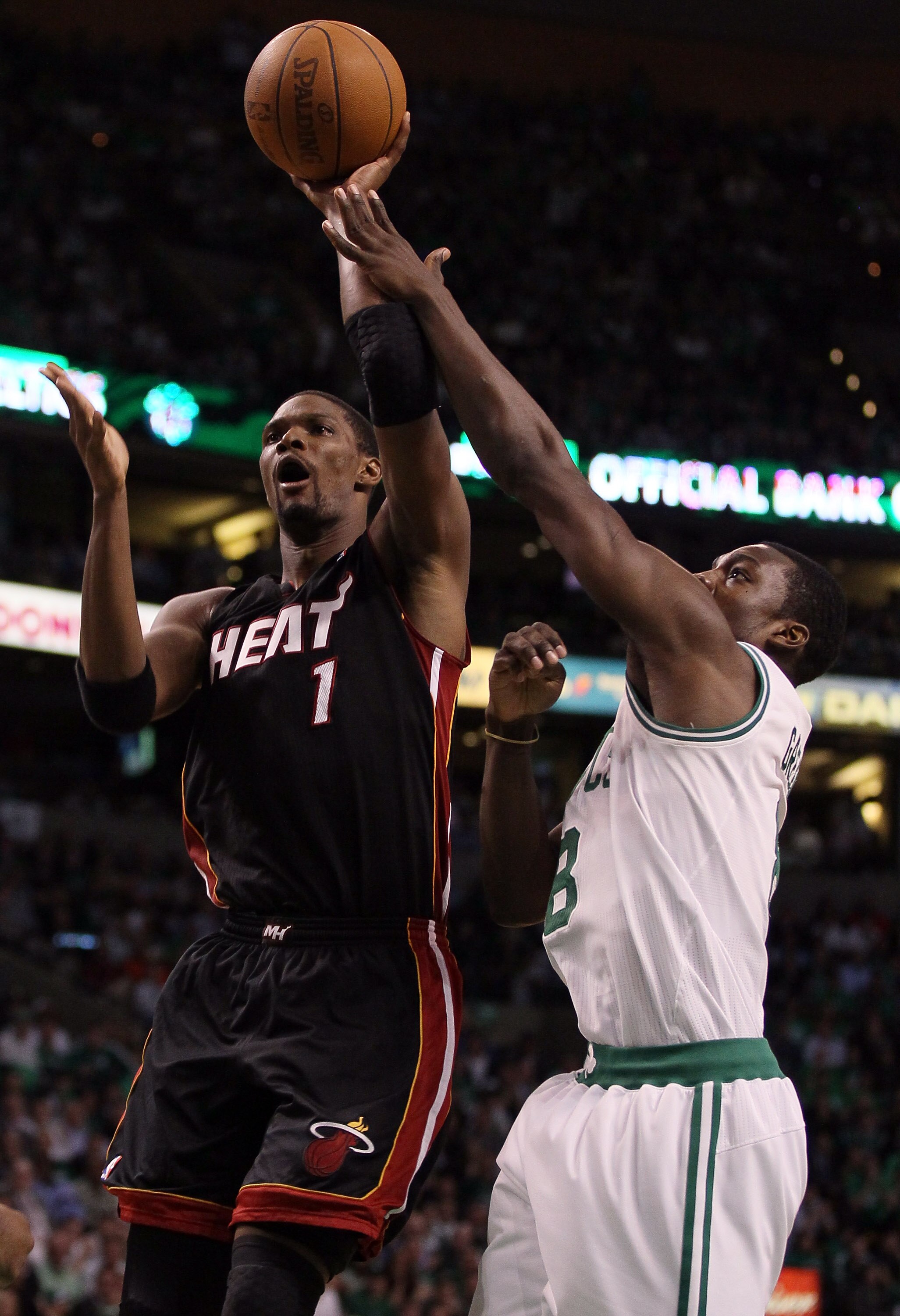 BOSTON, MA - MAY 09: Chris Bosh #1 of the Miami Heat takes a shot as Jeff Green #8 of the Boston Celtics defends in Game Four of the Eastern Conference Semifinals in the 2011 NBA Playoffs on May 9, 2011 at the TD Garden in Boston, Massachusetts.  The Miam