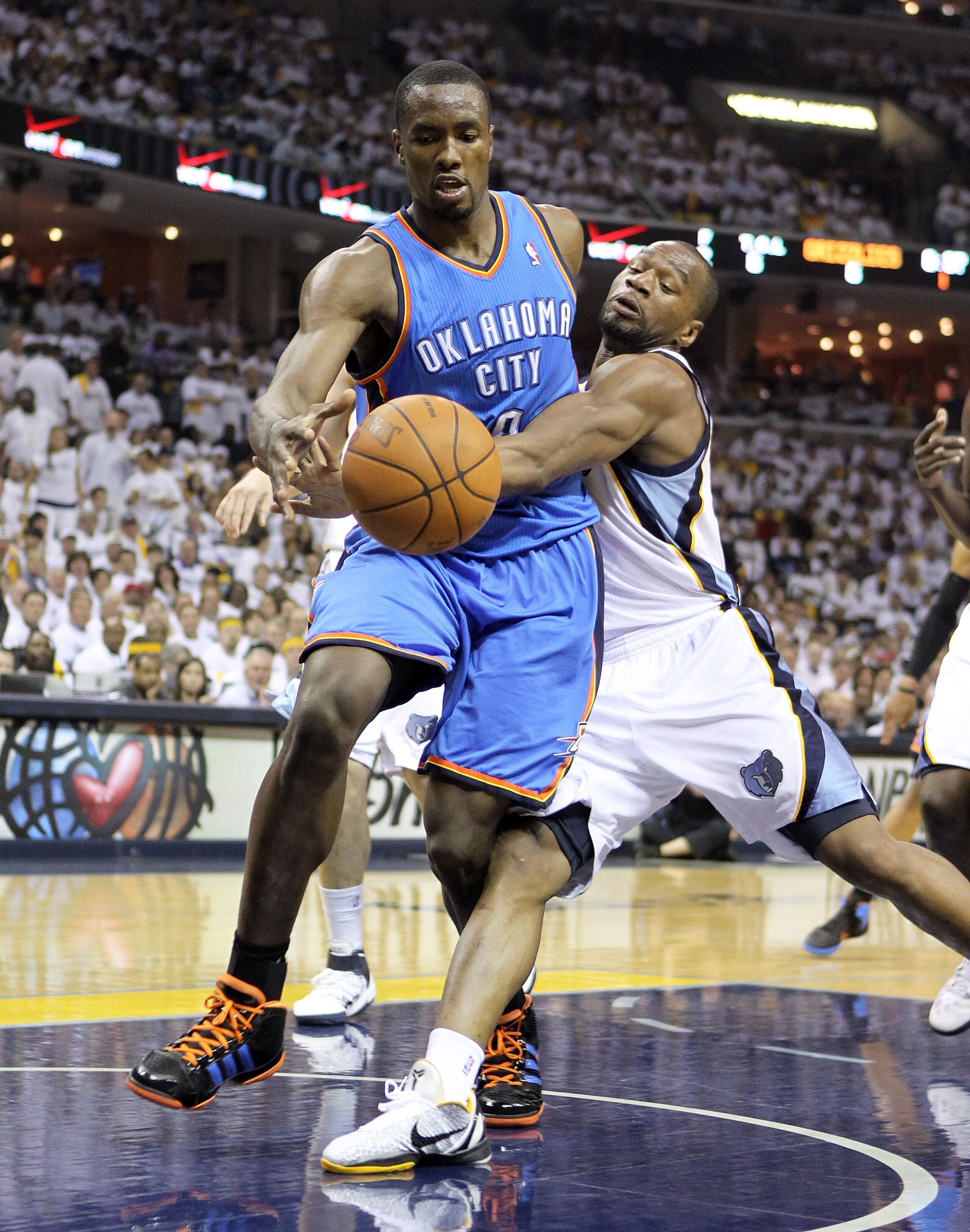 MEMPHIS, TN - MAY 07:  Serge Ibaka #9 of the Oklahoma City Thunder dribbles the ball while defended by Sam Young #4 of the Memphis Grizzlies in Game Three of the Western Conference Semifinals in the 2011 NBA Playoffs at FedExForum on May 7, 2011 in Memphi
