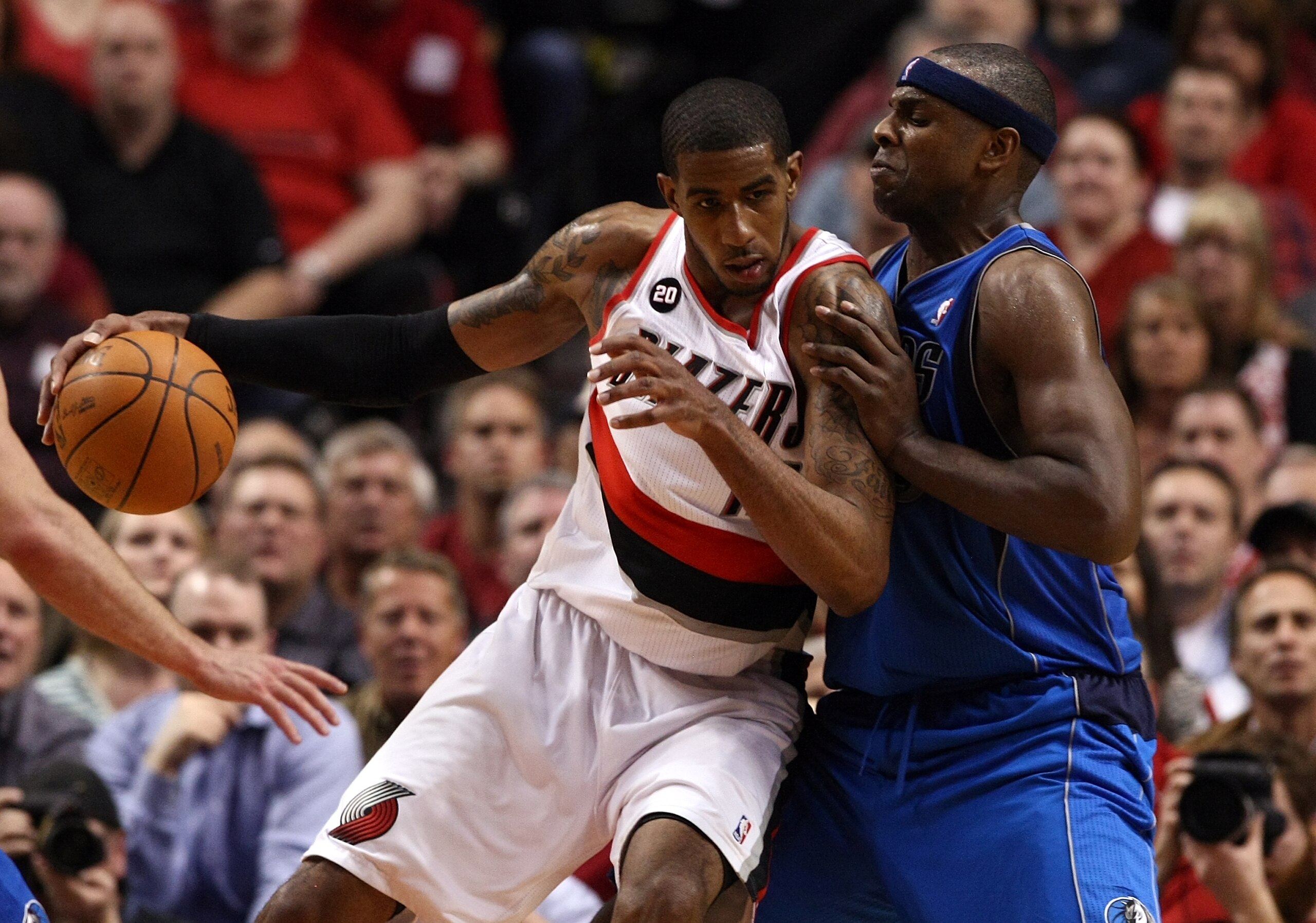 PORTLAND, OR - APRIL 21:  LaMarcus Aldridge #12 of the Portland Trail Blazers drives against Brendan Haywood #33 of the Dallas Mavericks in Game Three of the Western Conference Quarterfinals in the 2011 NBA Playoffs on April 21, 2011 at the Rose Garden in