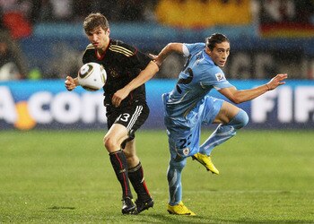 PORT ELIZABETH, SOUTH AFRICA - JULY 10:  Martin Caceres of Uruguay competes for the ball with Thomas Mueller of Germany during the 2010 FIFA World Cup South Africa Third Place Play-off match between Uruguay and Germany at The Nelson Mandela Bay Stadium on