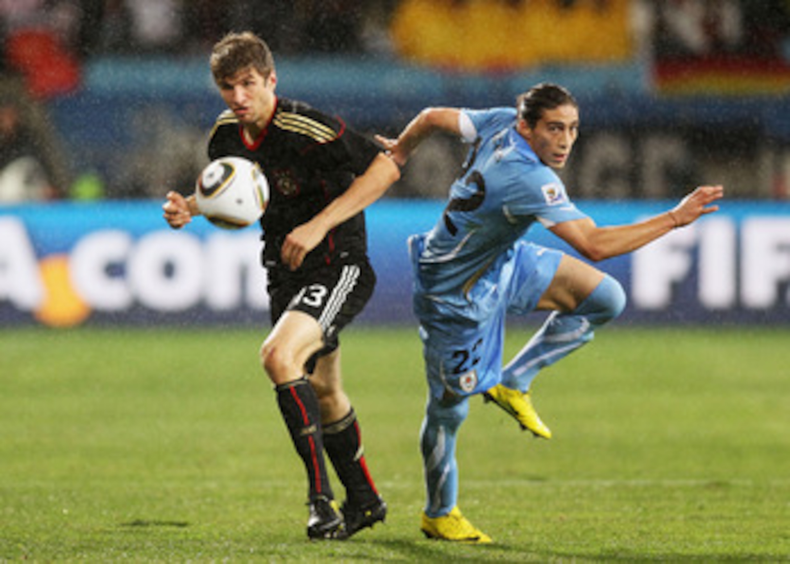 PORT ELIZABETH, SOUTH AFRICA - JULY 10:  Martin Caceres of Uruguay competes for the ball with Thomas Mueller of Germany during the 2010 FIFA World Cup South Africa Third Place Play-off match between Uruguay and Germany at The Nelson Mandela Bay Stadium on